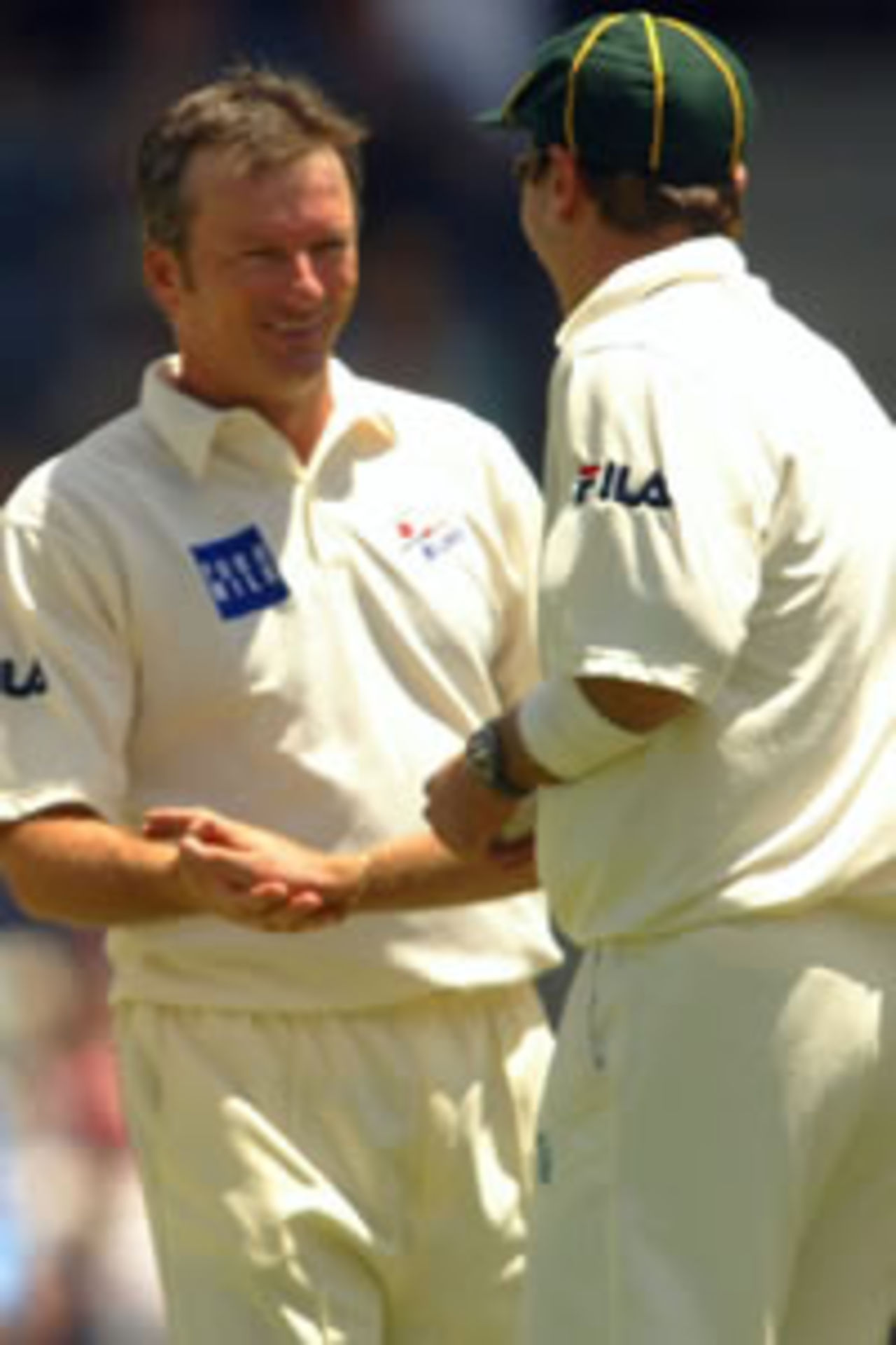 Steve Waugh of PM's XI celebrates with team mates Cade Brown after the wicket of Pathan of India caught Mark Cleary during the Prime Minister's XI against Inida cricket match on January 28, 2004 at Manuka Oval in Canberra, Australia.