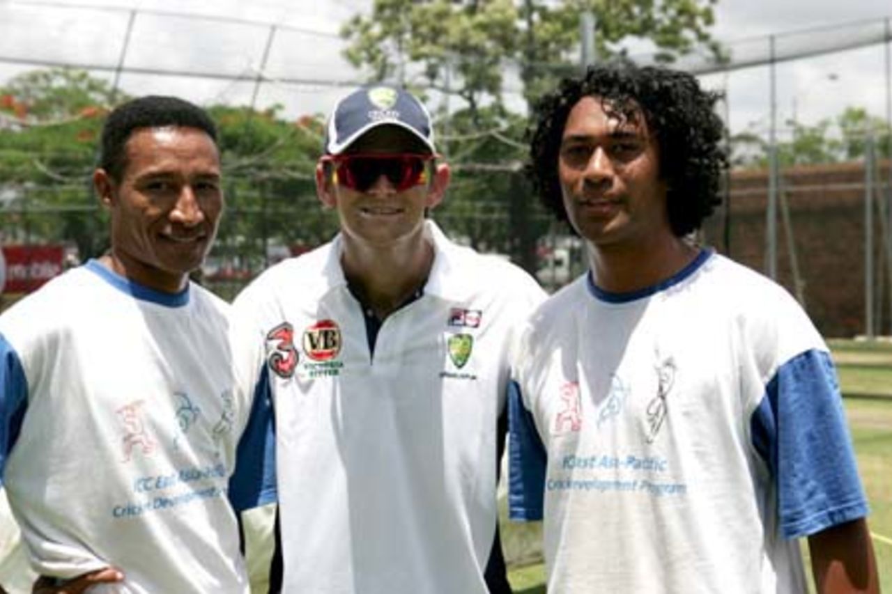EAP team members Toka Gaudi and Dunu Eliaba with Australian vice captain Adam Gilchrist