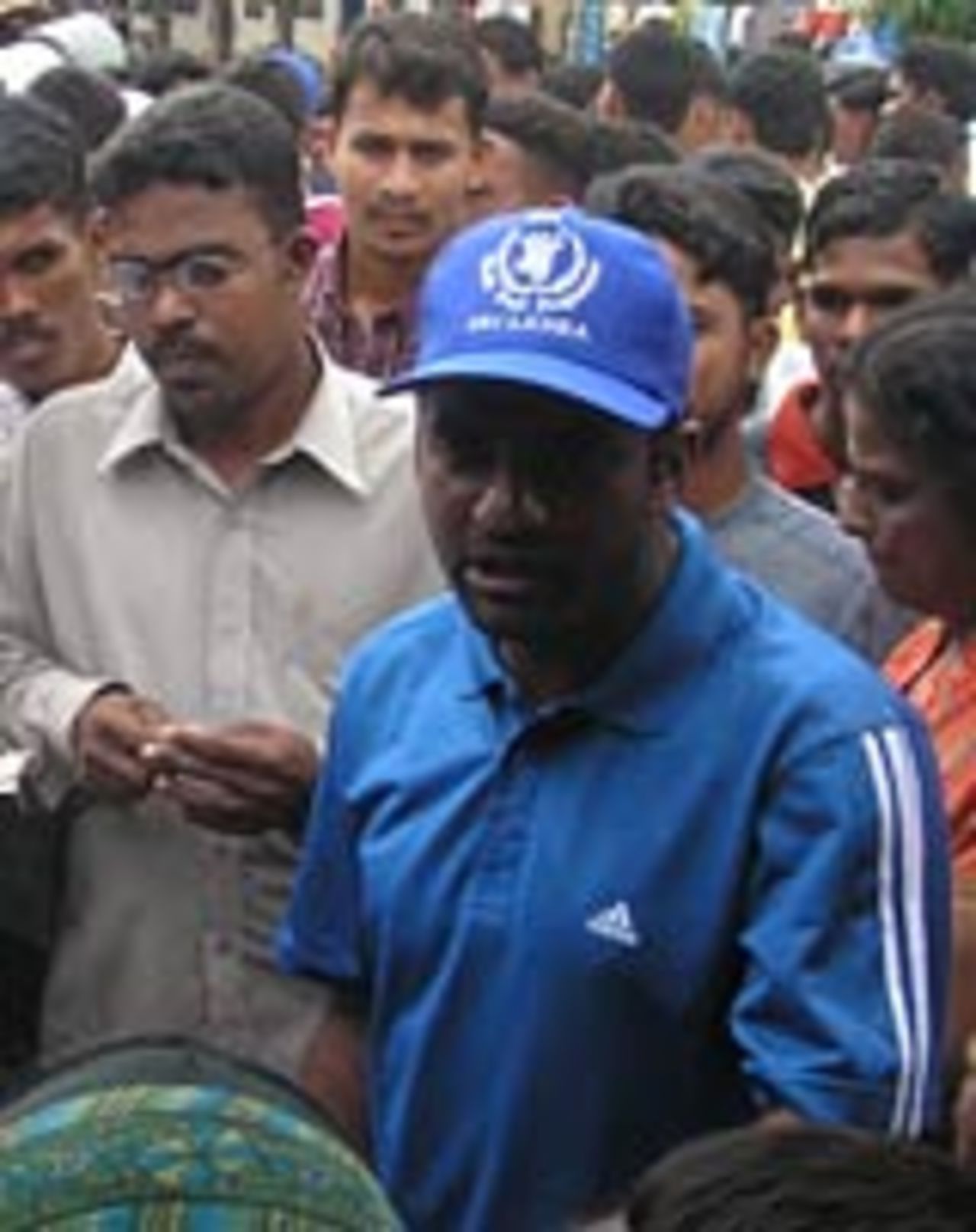 Muttiah Muralitharan talks to workers, January 3, 2005