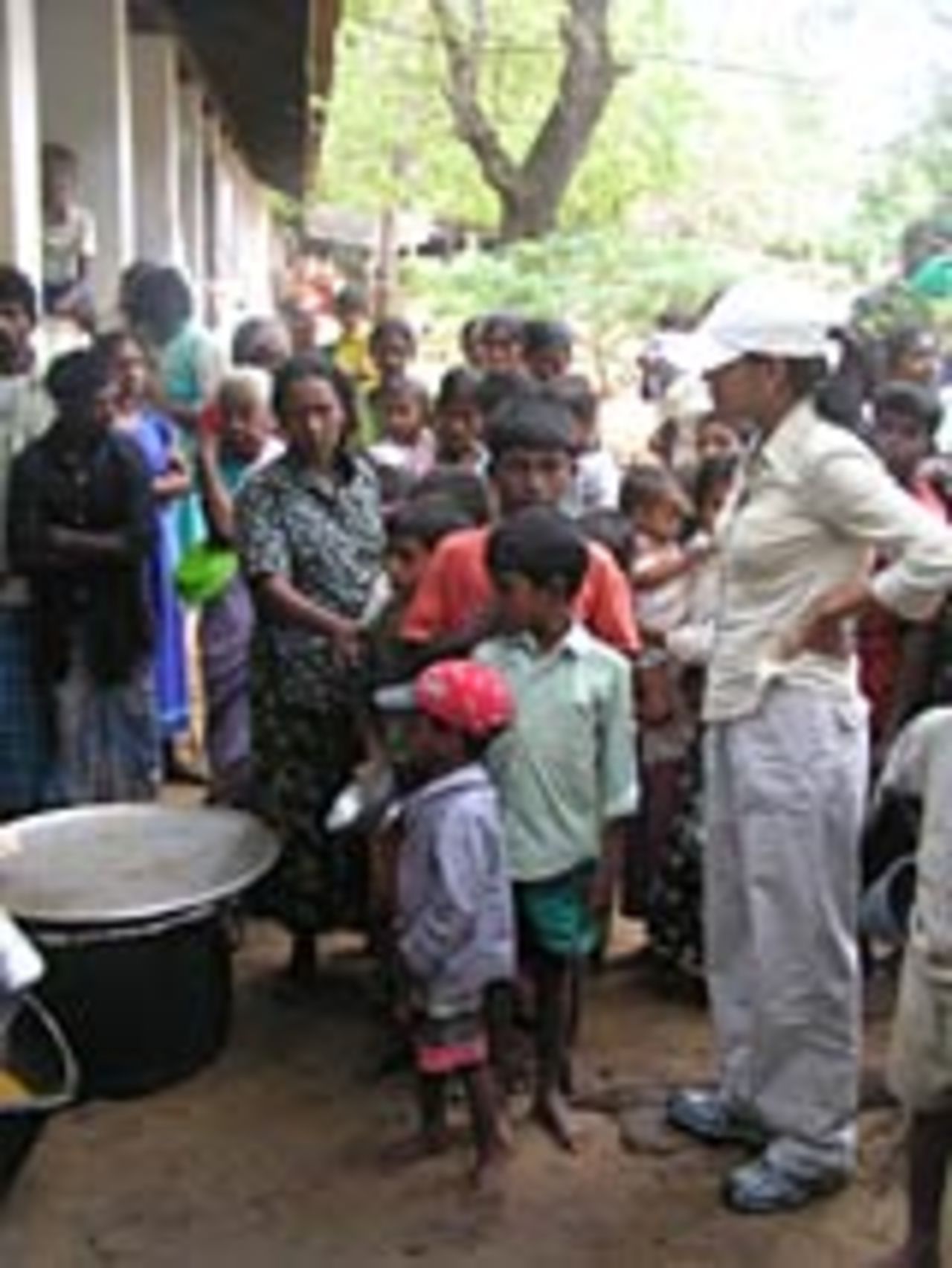 A queue of children waiting for food, January 6, 2005