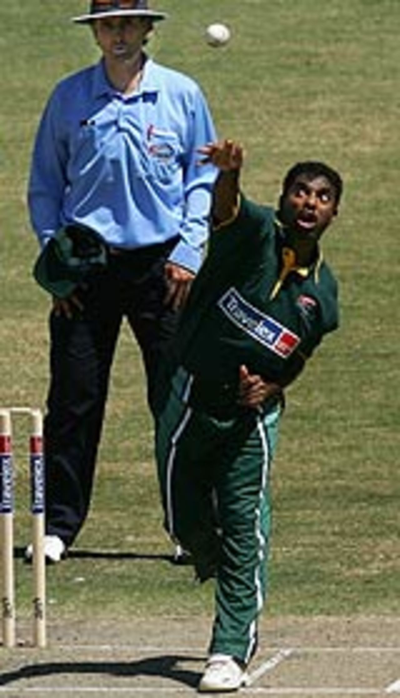 Muttiah Muralitharan bowls as Billy Bowden watches, ICC XI v Asian XI, Melbourne, January 10, 2005