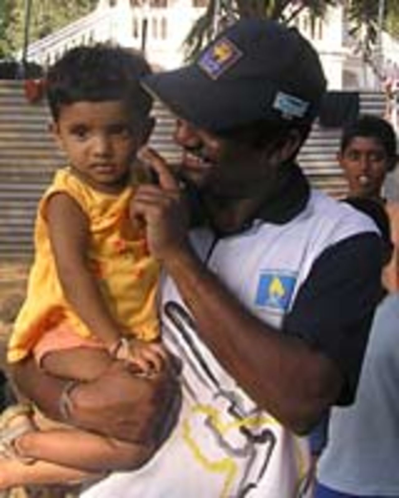 Murali with a young friend at the Matara Cricket-Aid camp, January 19 2005
