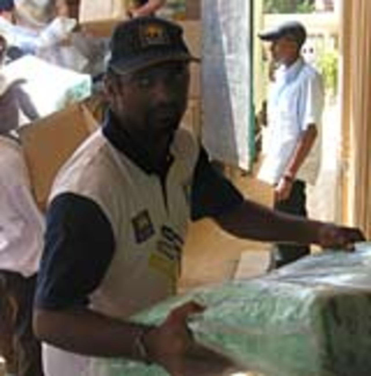 Murali as part of a human chain as aid is ferried into the stores, January 19, 2005