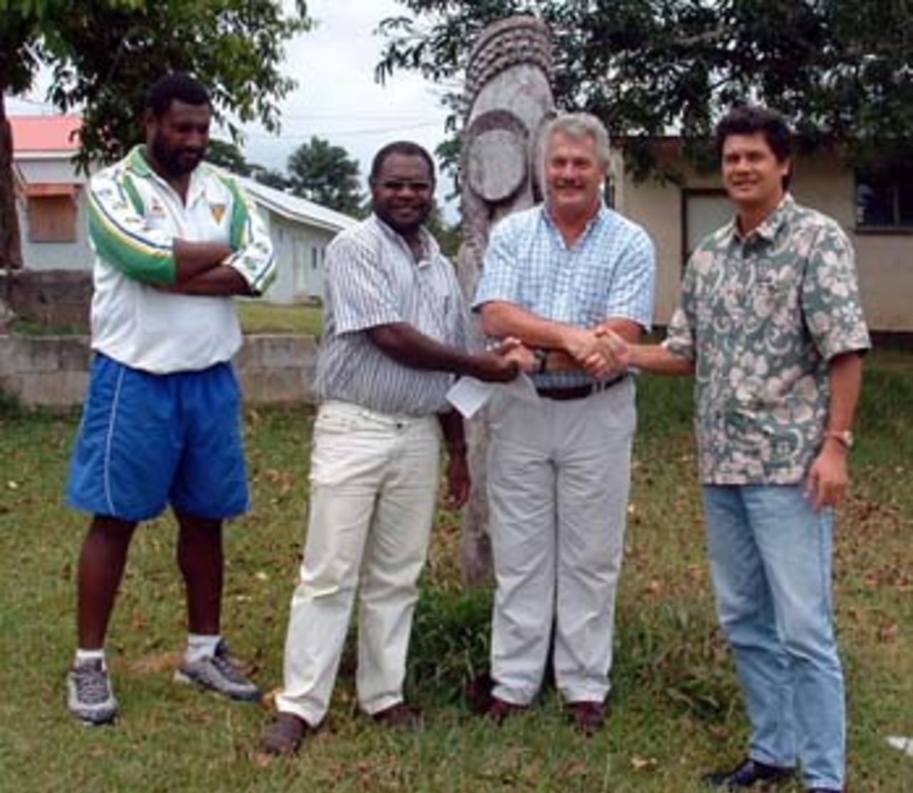 Vanuatu Cricket Association President Mark Stafford receives the cheque from Mr Raffin