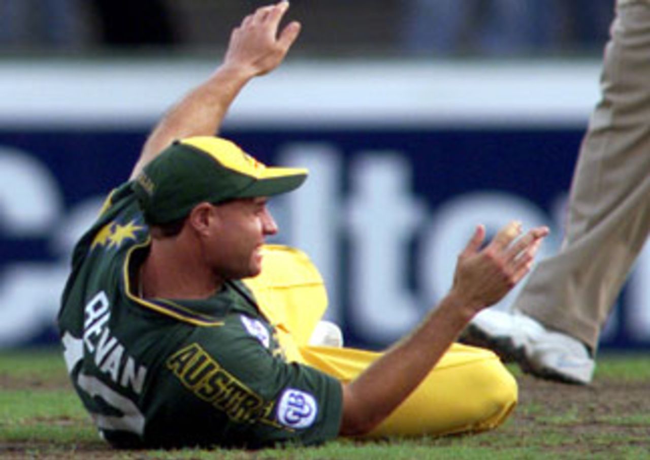 Michael Bevan lies on the ground with a dislocated finger after being struck by a ball. Australia v England, Carlton & United Series first final, February 13, 1999.
