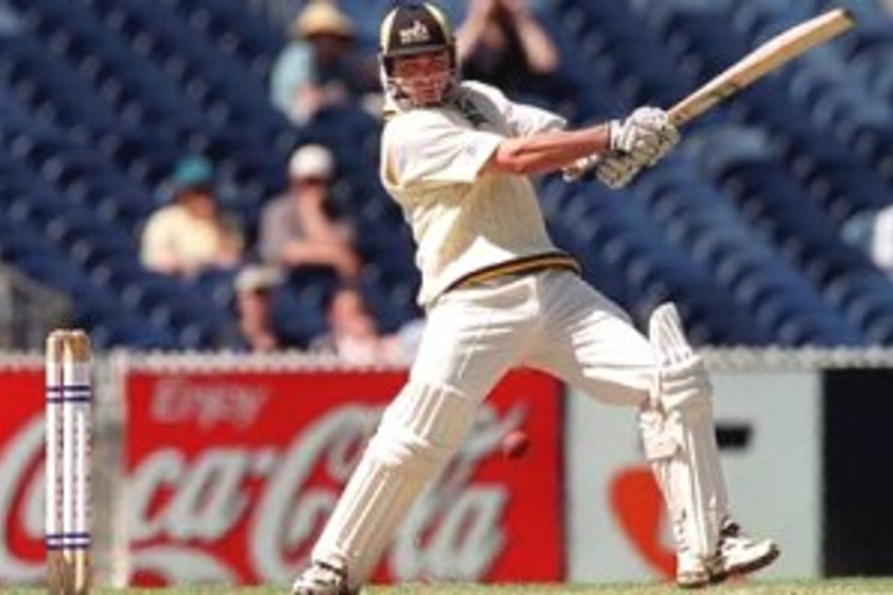 4 Dec 1999: Victorian keeper Darren Berry looks on as West Australia's Damien Martyn cracks a boundary off the bowling of John Davison during the Pura Milk Cup match played at the MCG, Melbourne, Australia.