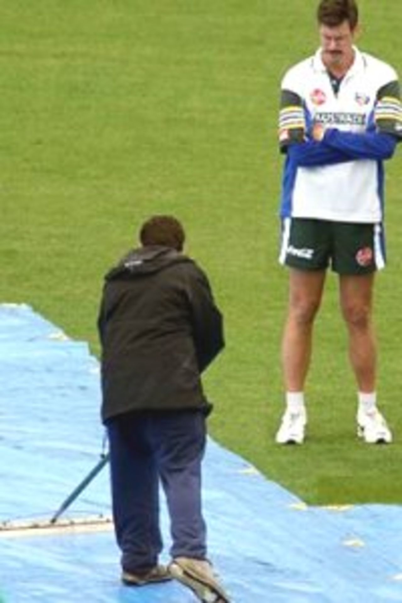 16 Feb 2000: Australian coach John Buchanan discusses the rain and wet ground while a ground attendant attempts to dry the ground, before the first one day international between Australia and New Zealand was abandonned at WestpacTrust Stadium, Wellington, New Zealand.