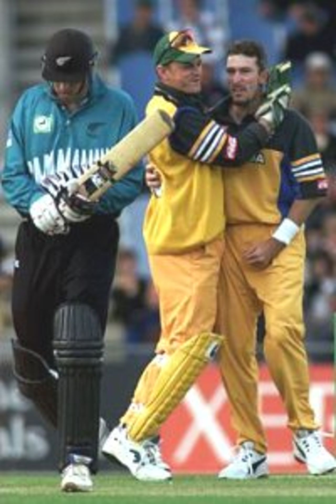 23 Feb 2000: Damien Fleming (right) gives Stephen Fleming of New Zealand a send off as Adam Gilchrist (centre) congratulates Damien Fleming of Australia during the third one day international between New Zealand and Australia at Carisbrook, Dunedin, New Zealand.