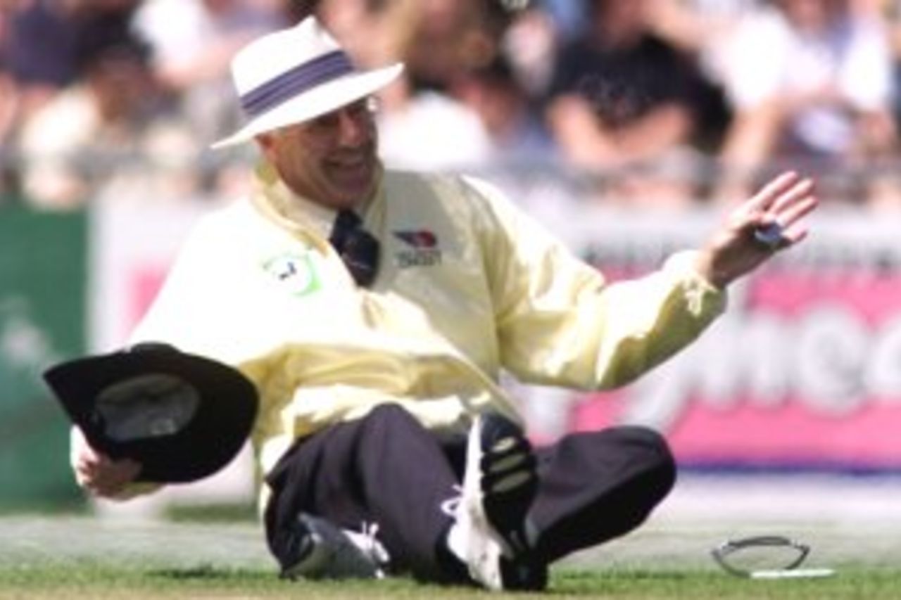 23 Feb 2000: Umpire Steve Dunne signals a four from Adam Gilchrist of Australia after falling over avoiding the ball, during the third one day international between New Zealand and Australia at Carisbrook, Dunedin, New Zealand.
