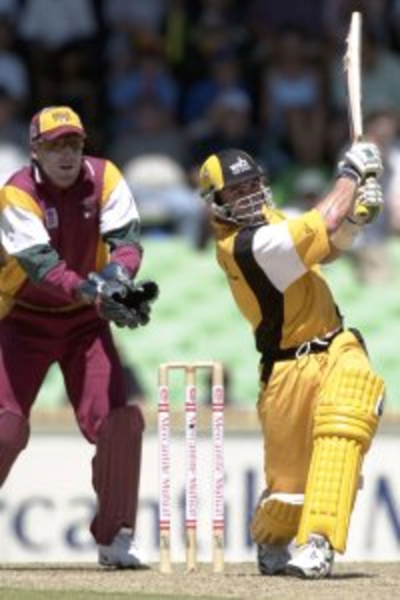 27 Feb 2000: Ryan Campbell of the Western Warriors smashes a ball to the boundry on his way to scoring a toatal of 108 runs, as Queensland Bulls wicketkeeper Wade Secombe looks on, during the Mercantile Mutual one day cricket final played at the WACA, Perth Australia.