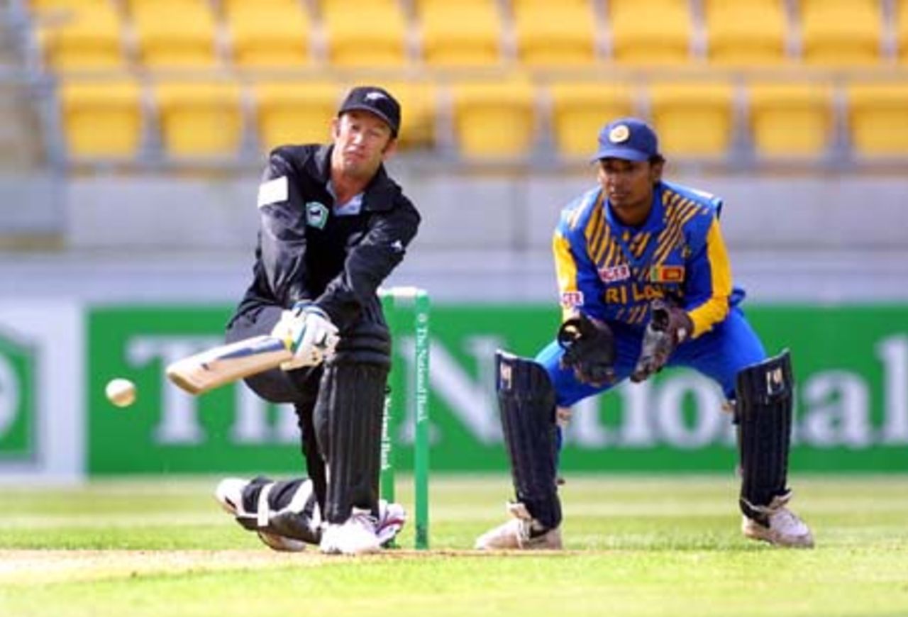 New Zealand batsman Chris Harris sweeps during his innings of 56 as Sri Lankan wicket-keeper Kumar Sangakkara looks on. 2nd One-Day International: New Zealand v Sri Lanka at WestpacTrust Stadium, Wellington, 3 February 2001.