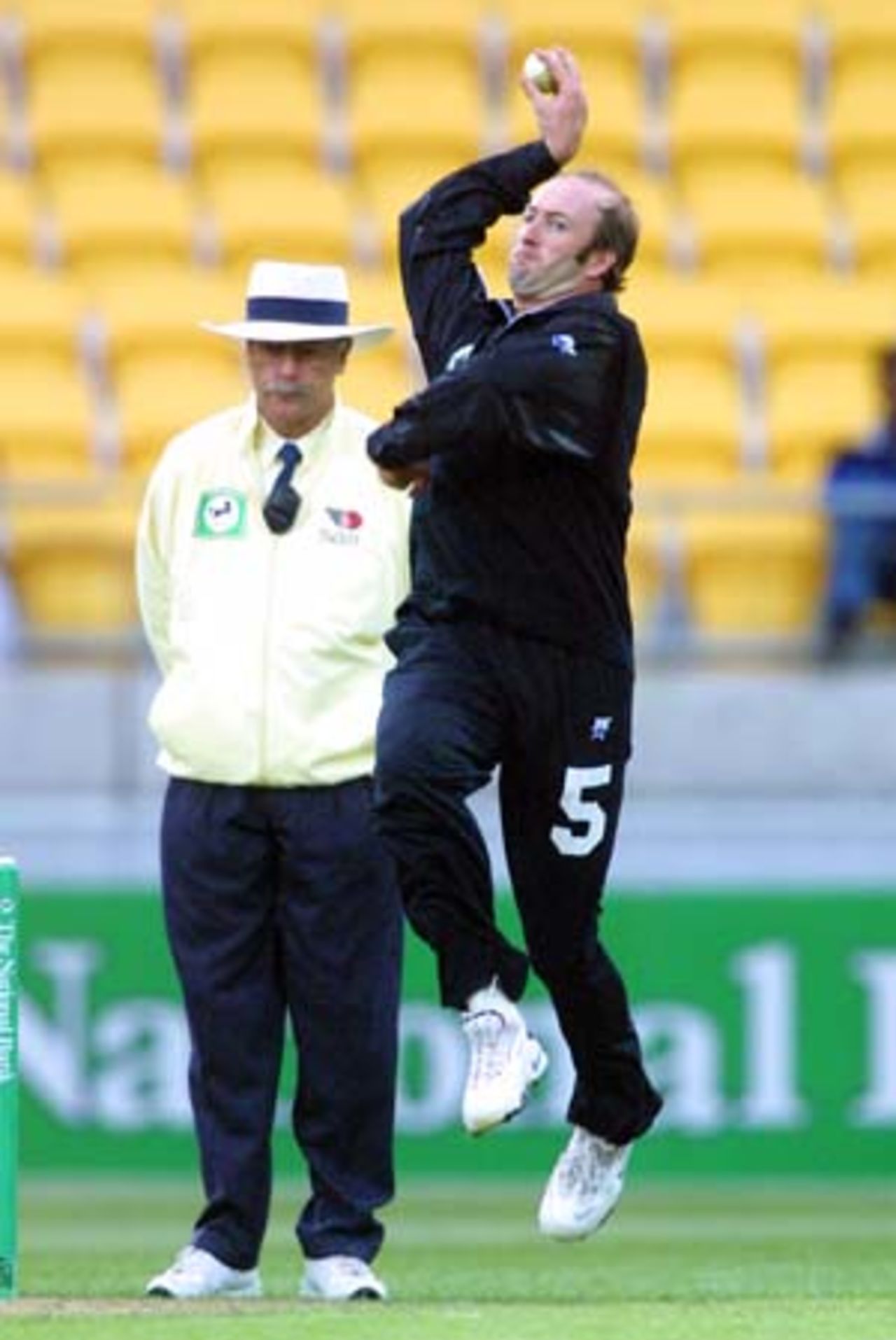 New Zealand medium pace bowler Chris Harris bowls under the watchful eye of umpire Steve Dunne during his spell of 0-38 from 10 overs. 2nd One-Day International: New Zealand v Sri Lanka at WestpacTrust Stadium, Wellington, 3 February 2001.