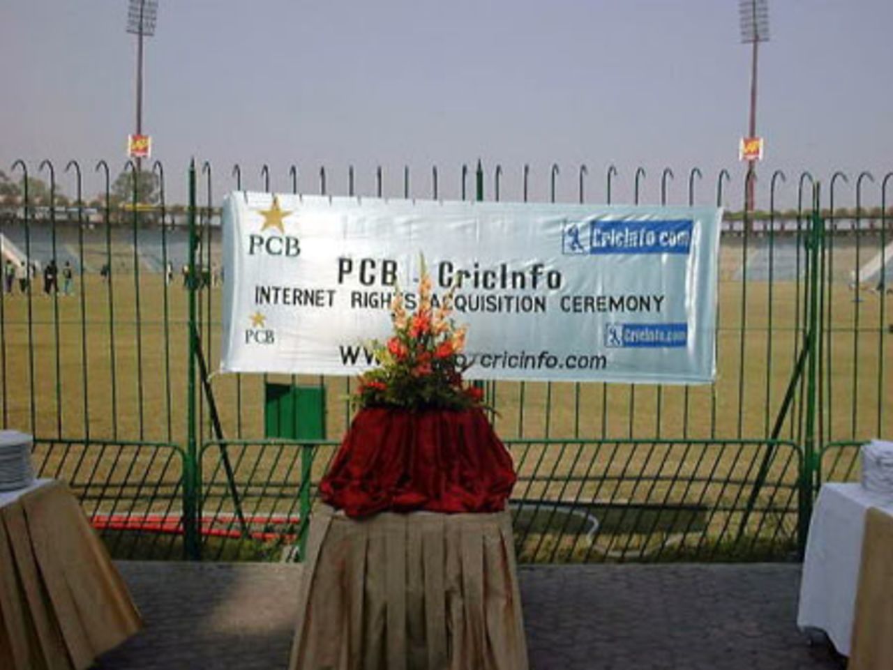 A view of the banner with Pakistan players practicing in the background at PCB - CricInfo Internet Rights Acquisition Ceremony at Gaddafi Stadium, Lahore 5 Feb 2001