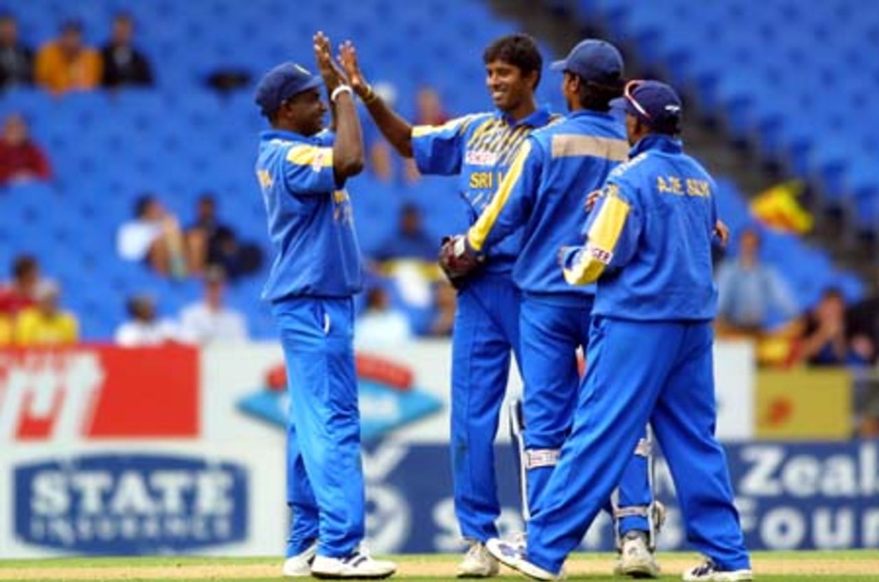 Sri Lankan off spinner Kumar Dharmasena (second from left) is congratulated by teammates for dismissing New Zealand batsman Craig McMillan, bowled for 61. From left, they are captain Sanath Jayasuriya, wicket-keeper Kumar Sangakkara and Aravinda de Silva. 3rd One-Day International: New Zealand v Sri Lanka at Eden Park, Auckland, 6 February 2001.
