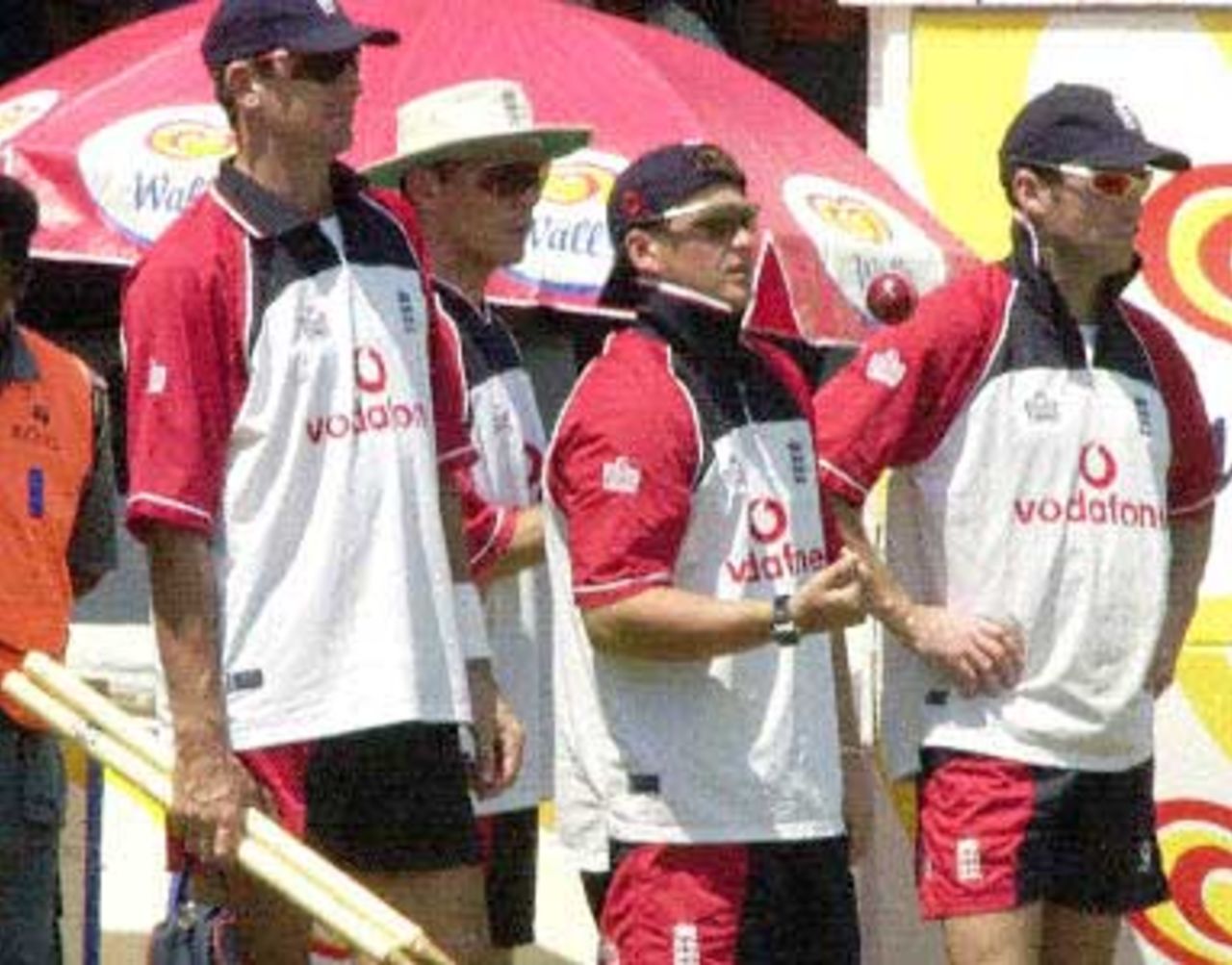 English fast bowler Darren Gough (C) flanked by teammates Andrew Caddick (R) and Craig White (L) and another unidentified player watches batting practice 05 February 2001 in the first day of the first practice match against a Sri Lankan board president's eleven. England are due to play three tests and three one-day internationals against the home team in their first tour of Sri Lanka in eight years.