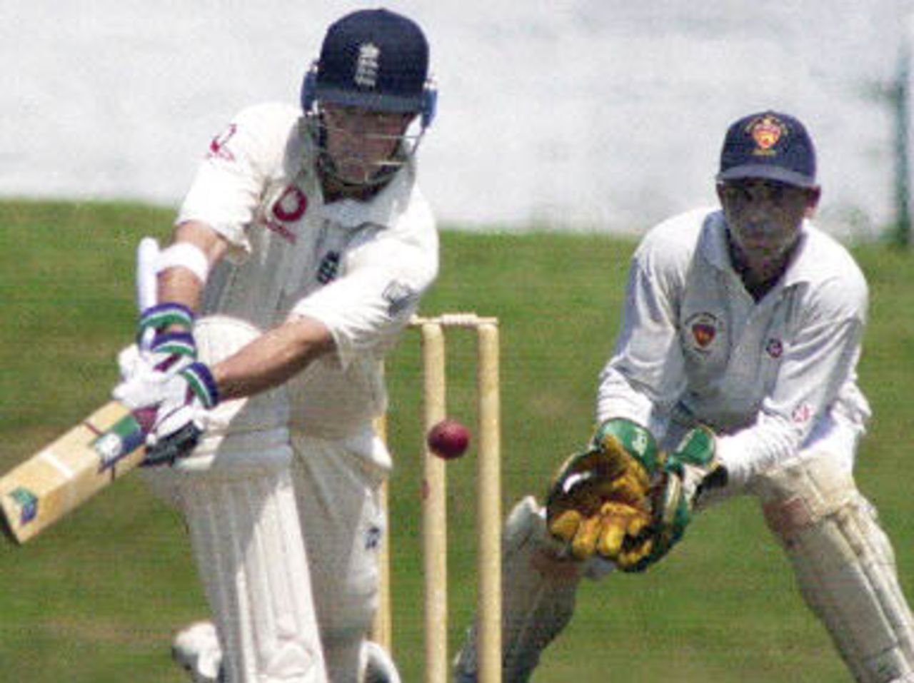 English opener Marcus Trescothick in action 05 February 2001 in the first day of the first practice match against a Sri Lankan board president's eleven as wicket keeper Malintha Perera looks on. England is due to play three tests and three one-day internationals against the home team in their first tour of Sri Lanka in eight years.