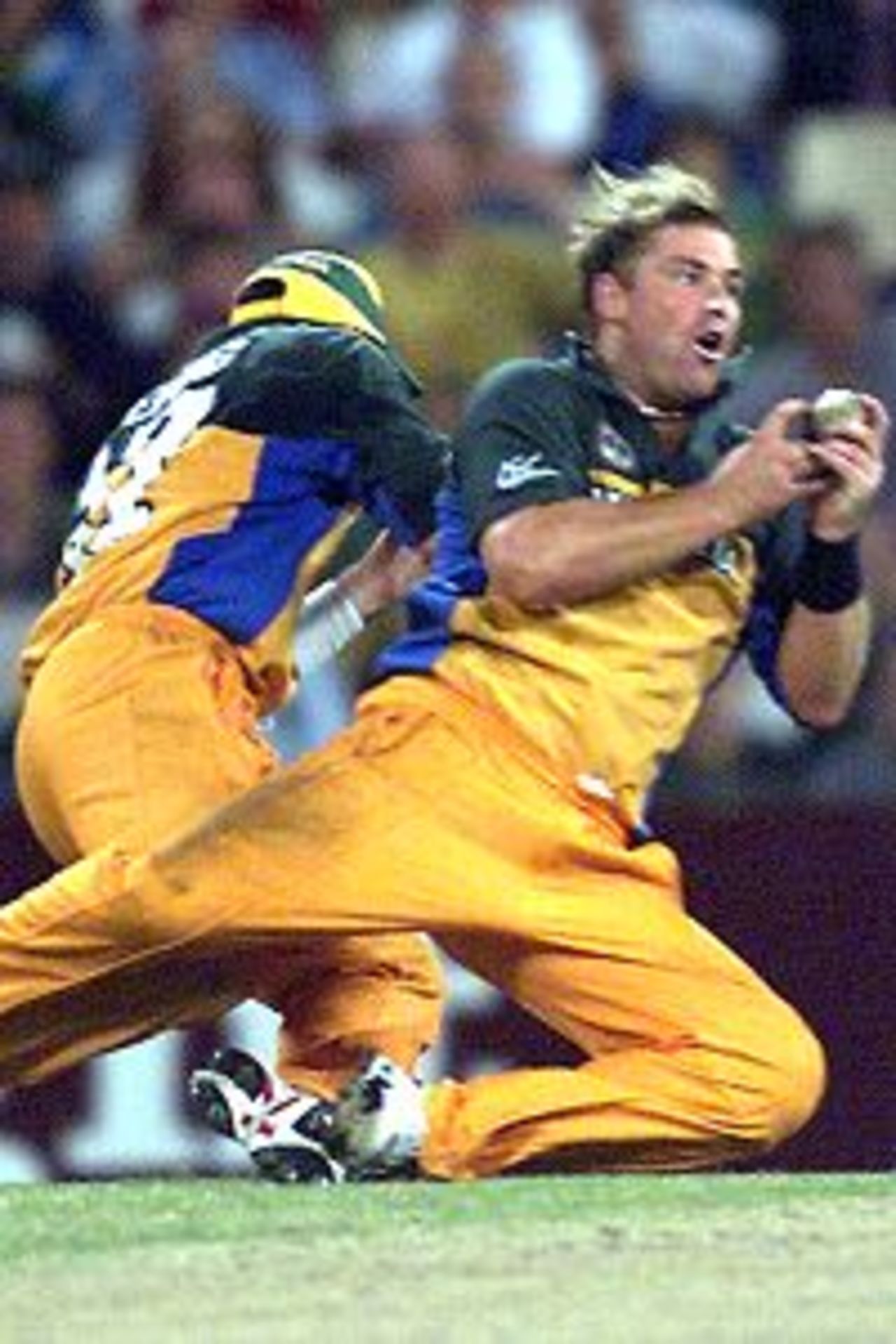 Shane Warne of Australia collides with Damien Fleming whilst taking the caught and bowled wicket of Sylvester Joseph of the West Indies for 18 during the first final of the Carlton Series One Day Internationals between Australia and West Indies at the Sydney Cricket Ground, Sydney, Australia. Australia won the game by 134 runs.