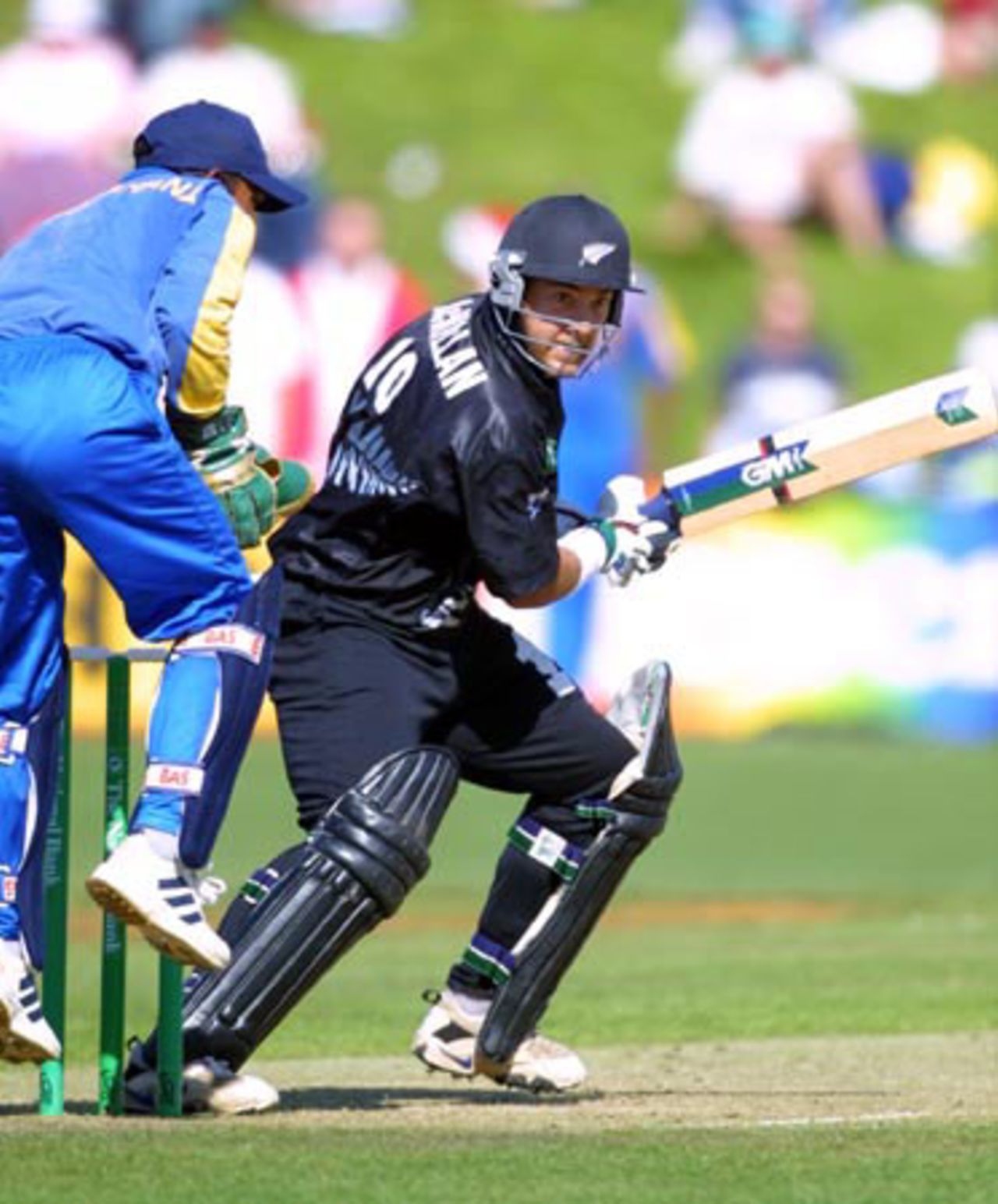 New Zealand batsman Craig McMillan cuts a ball through backward point during his innings of 19 as Sri Lankan wicket-keeper Romesh Kaluwitharana looks on. 4th One-Day International: New Zealand v Sri Lanka at WestpacTrust Park, Hamilton, 8 February 2001.