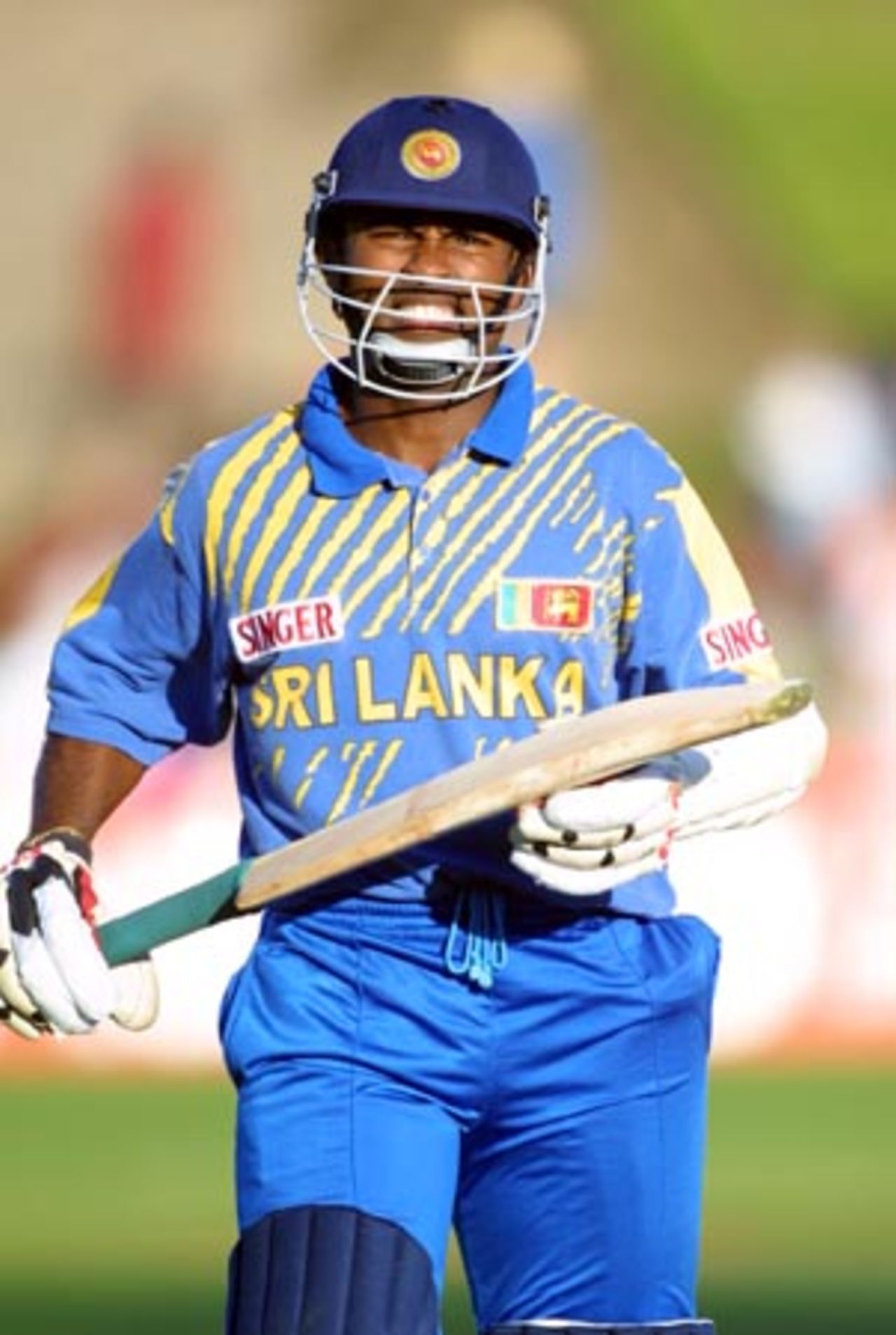 Disappointed Sri Lankan opening batsman Romesh Kaluwitharana walks off the field after being adjudged leg before wicket off the bowling of New Zealand medium pace bowler Nathan Astle for 34 by umpire Evan Watkin. 4th One-Day International: New Zealand v Sri Lanka at WestpacTrust Park, Hamilton, 8 February 2001.