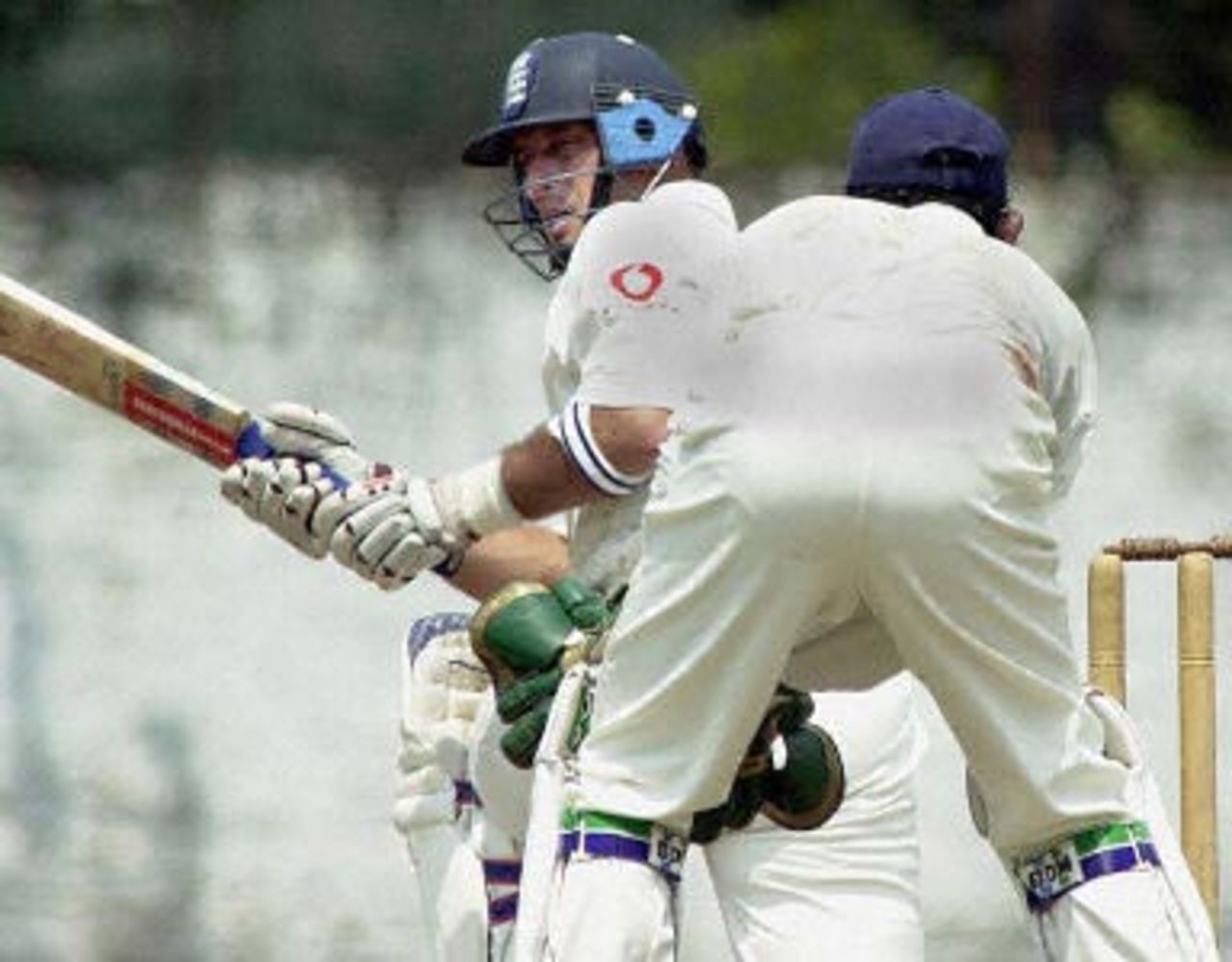 England's captain Nasser Hussain bats 08 February 2001 in the first day of the second practice match against a Sri Lanka Board President's XI as wicketkeeper Prasanna Jayawardena (back to the camera) looks on. England is due to play three Tests and three one-day internationals against the home team in their first tour of Sri Lanka in eight years.