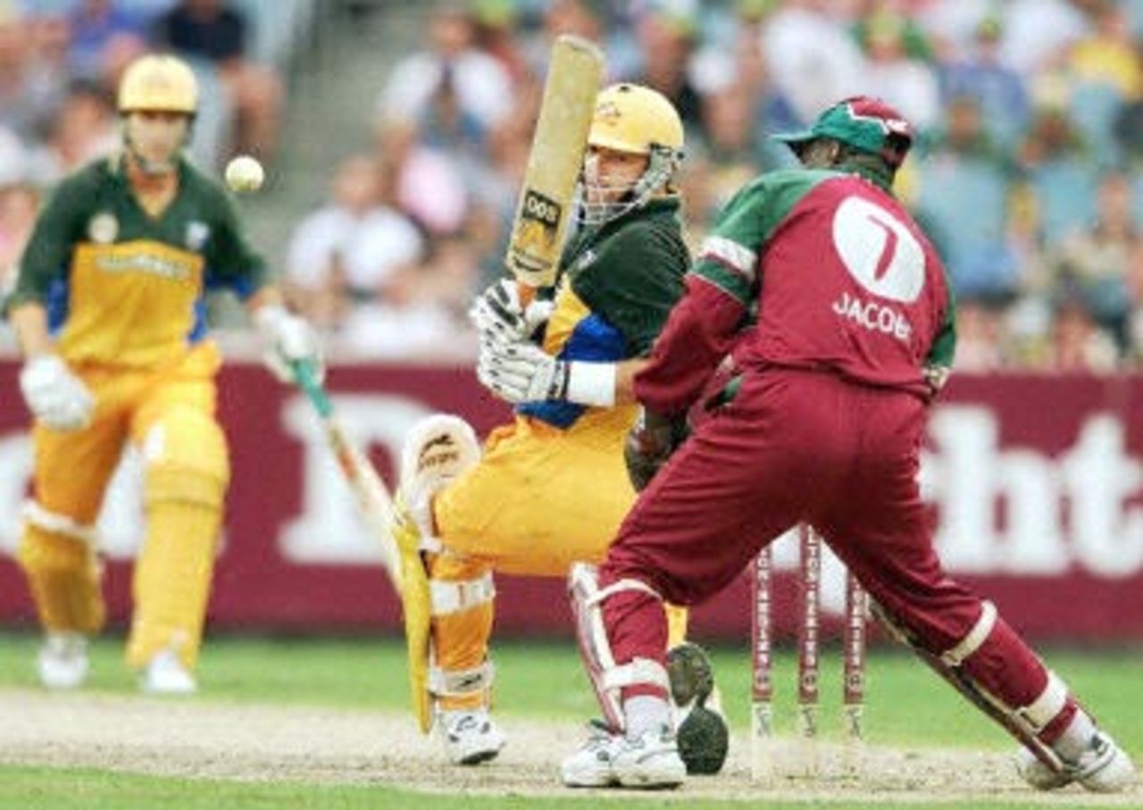 Australian batsman Mark Waugh (C) sweeps a ball fine as fellow batsman Michael Beavan (L) and wicketkeeper Ridley Jacobs (R) follow the ball's progress as Waugh scores a century during the second one-day final against the West Indies at the MCG in Melbourne 09 February 2001. Australia amassed the huge total of 338-6 with Waugh topscoring with 173.