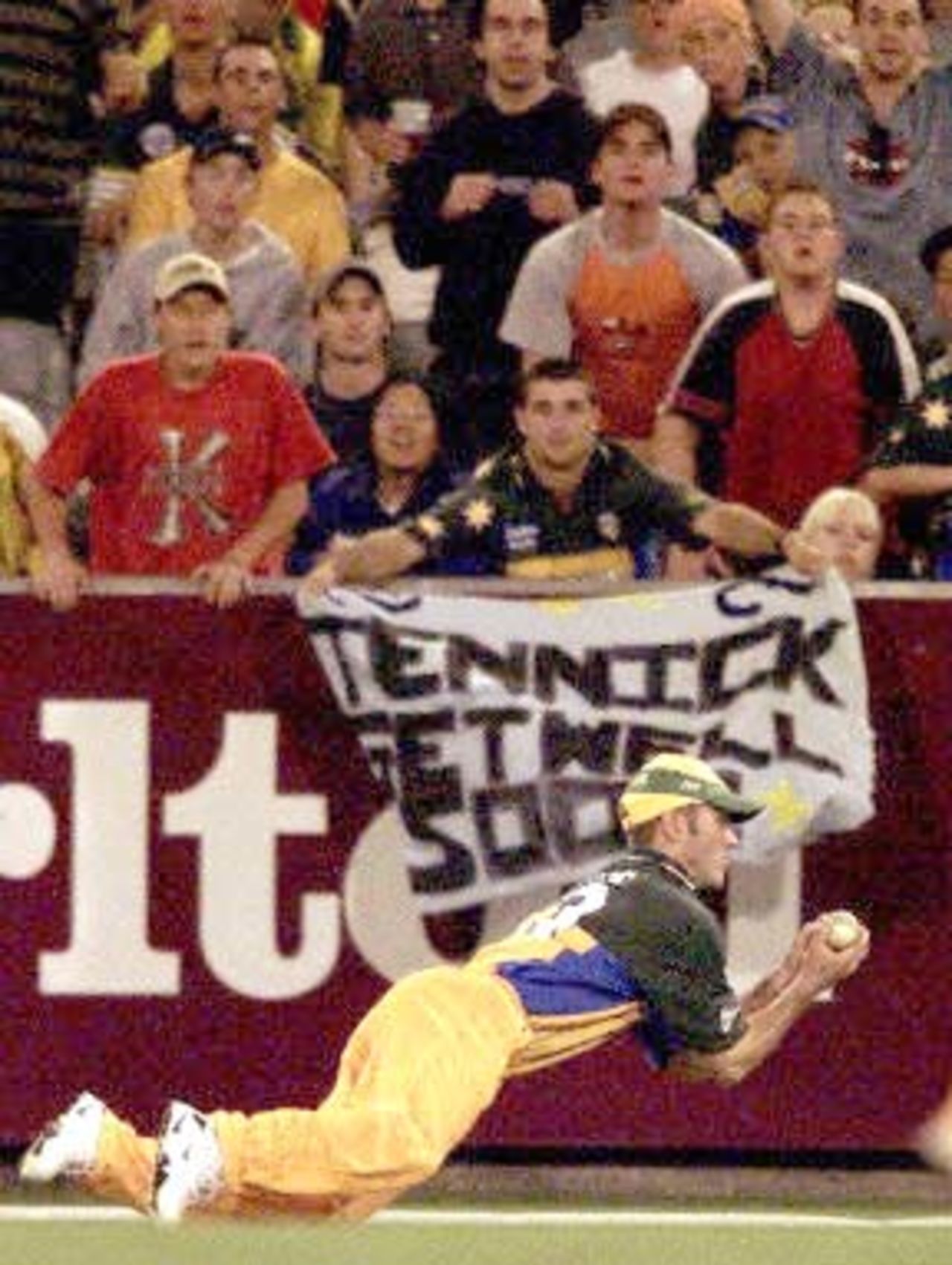 Australian fieldsman Damien Martyn dives full-lenght to catch West Indian batsman Marlon Samuels during the 2nd one-day final against the West Indies at the MCG in Melbourne 09 February 2001. Australia amassed the huge total of 338-6 with Mark Waugh topscoring with 173 and in reply the West Indies are 250-7 after 40 overs.