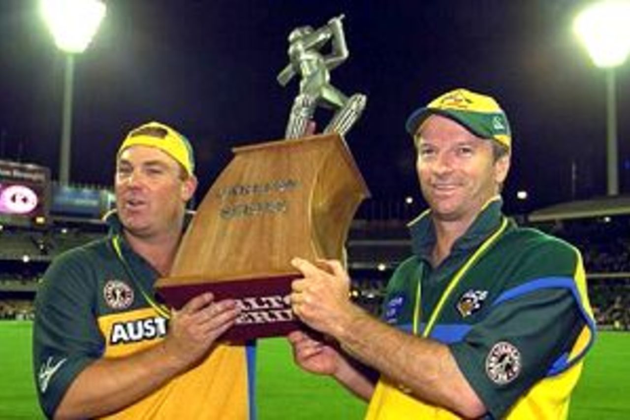 Shane Warne and Steve Waugh of Australia celebrate with the trophy after Australia's series win in the second Final of the Carlton One Day International Series between Australia and the West Indies, played at the Melbourne Cricket Ground in Melbourne, Australia