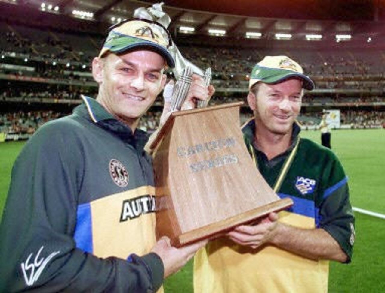 The Australian captain Steve Waugh (R) and vice captain Adam Gilchrist (L) celebrate with the trophy after winning the 2nd one-day final against the West Indies to take out the series 2-0 at the MCG in Melbourne 09 February 2001. Australia amassed the huge total of 338-6 with Mark Waugh topscoring with 173 and in reply the West Indies scored 299 to lose by 39 runs.