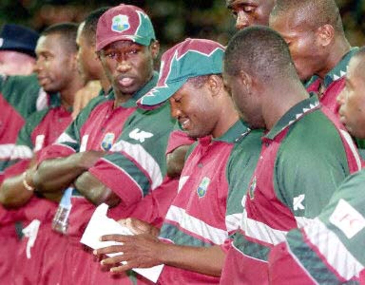 West Indian batsman Brian Lara (C) looks bemused as he opens the envelope after being named man of the series after Australia won the 2nd one-day final against the West Indies to take out the series 2-0 at the MCG in Melbourne 09 February 2001. Australia amassed the huge total of 338-6 with Mark Waugh topscoring with 173 and in reply the West Indies scored 299 to lose by 39 runs.