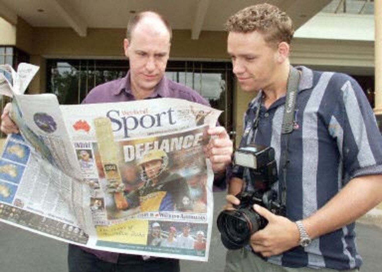 Australian journalists read the headlines as they wait for the arrival of Australian batsman Mark Waugh, who is meeting with the International Cricket Council (ICC) anti-corruption unit at an inner-city hotel in Melbourne, 10 February 2001. Waugh is facing allegations of receiving large amounts of cash from a Indian bookmaker.
