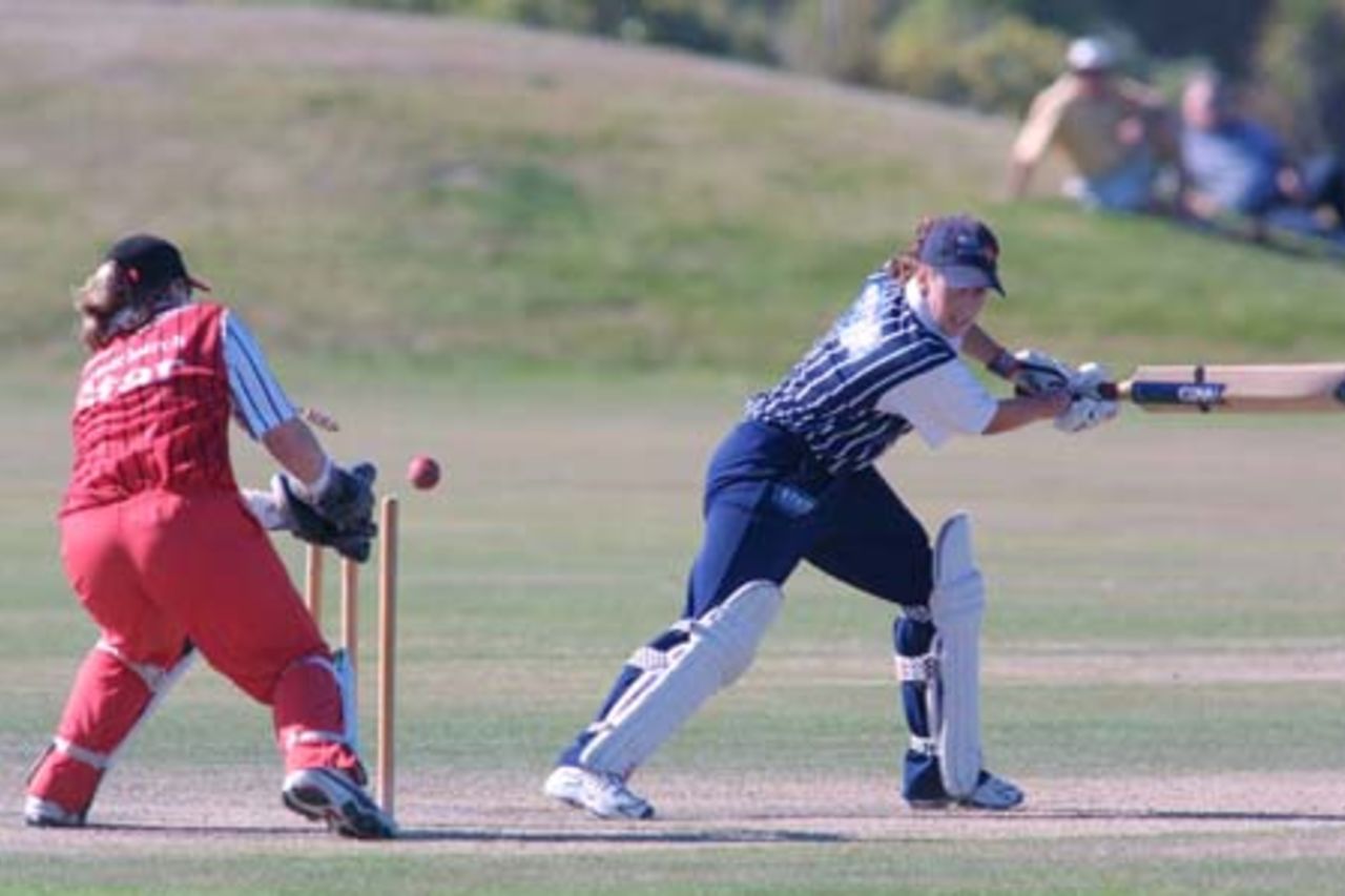 Auckland batsman Helen Watson plays and misses a wide ball outside off stump during her innings of 44 not out. Canterbury wicket-keeper Jo Strachan knocks off the bails without the ball in her gloves, though Watson's back foot remained anchored in the crease. State Insurance Cup Final: Canterbury Women v Auckland Women at Village Green, Christchurch, 10 February 2001.
