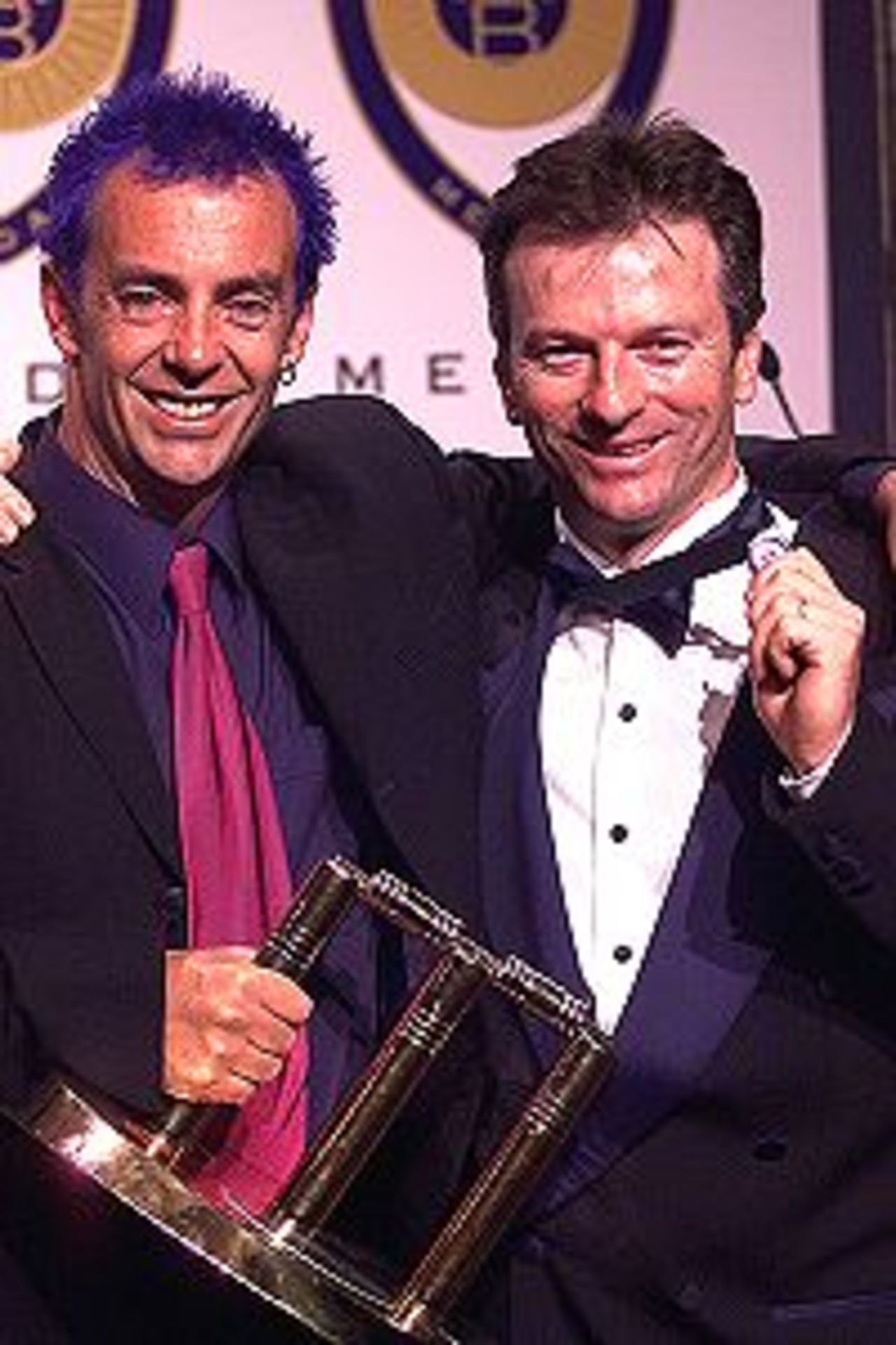 12 Feb 2001: Australian Test Player of the Year winner, Colin Miller celebrates with Border Medallist Steve Waugh at the Allan Border Medal Presentation held at Crown Casino in Melbourne, Australia.