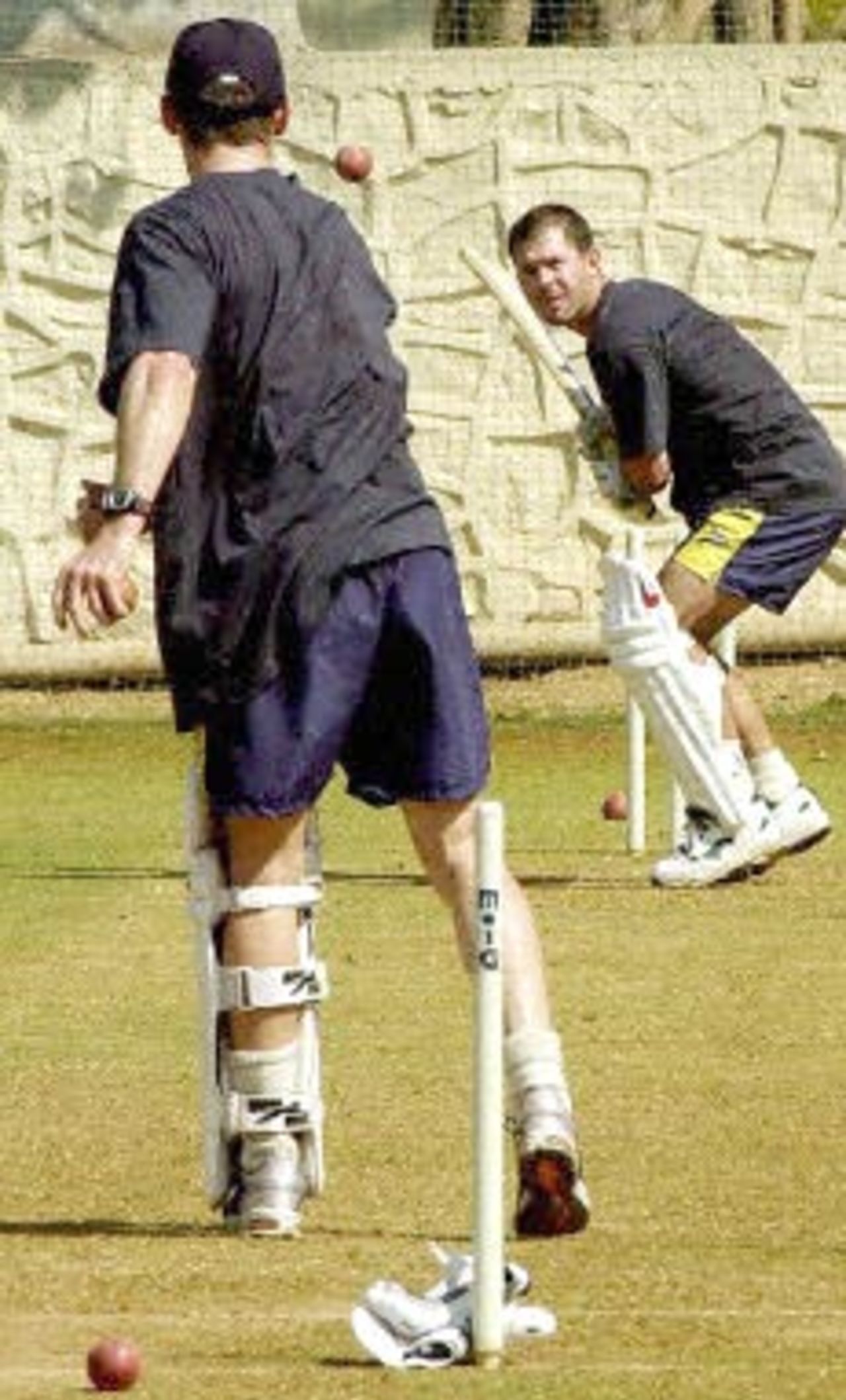 Australian batsman Ricky Ponting readies to strike the ball sent down by Damien Martyn at the first net session of the Australian Cricket team 15 February 2001 at the MIG stadium in Bombay.The Australian cricket team will be playing three test matches and five one-day internationals during their India tour.
