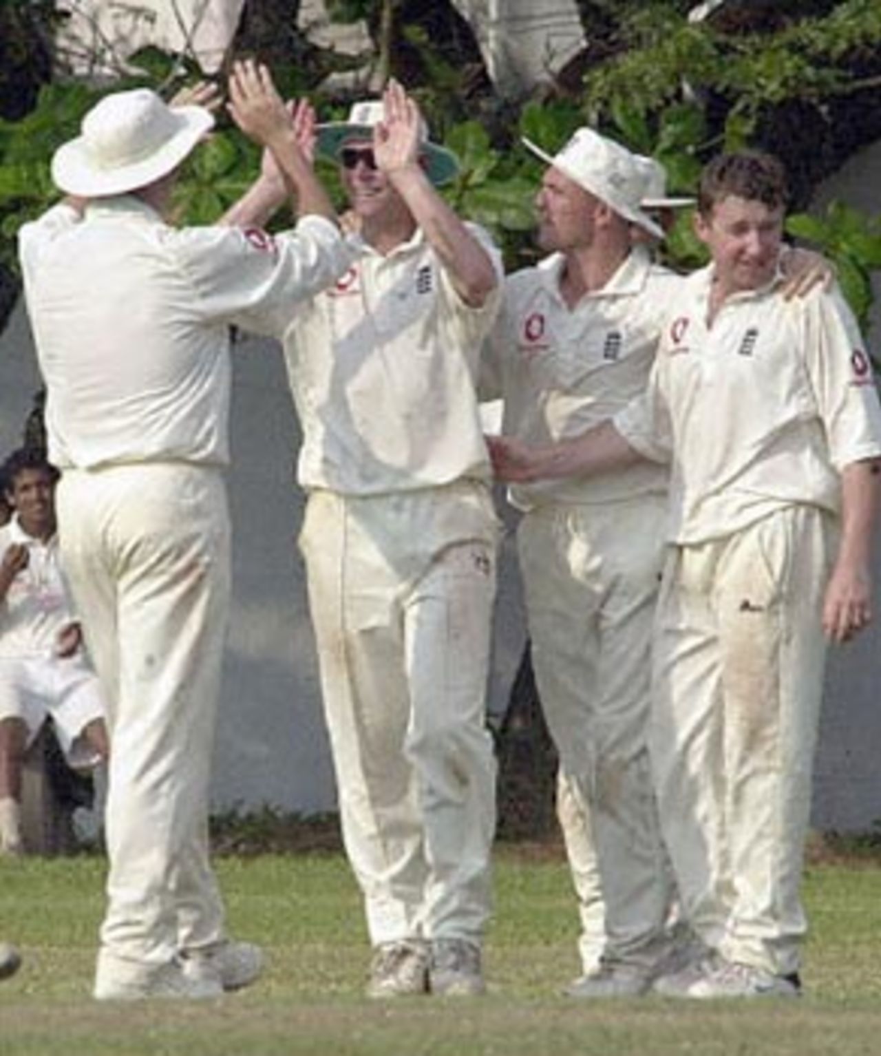 England's Matthew Hoggard (second from left) is congratulated by team mates after taking a catch on the boundary edge to dismiss Board Presidents XI batsman Niroshan Bandaratilake (not in picture) off Robert Croft (on right) on the first day of a four day cricket match on 15 February 2001 in Southern Sri Lanka at Matara . Board President's XI made 273 in their first innings.