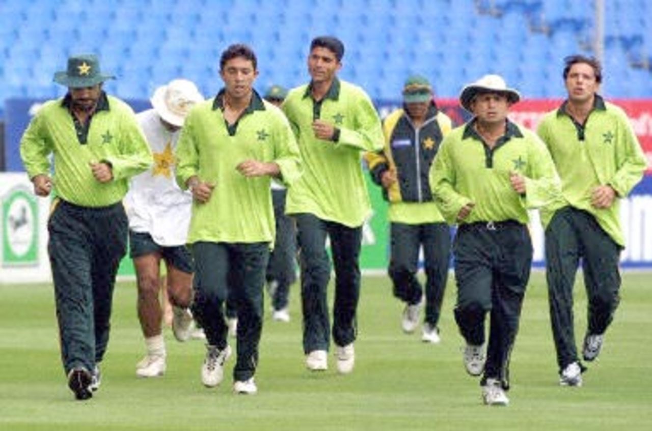 The Pakistan cricket team goes for a light jog in the rain around Eden Park in Auckland 16 February 2001 during a training session. Pakistan will play New Zealand's Black Caps in the first of five one-day internationals starting 17 February.