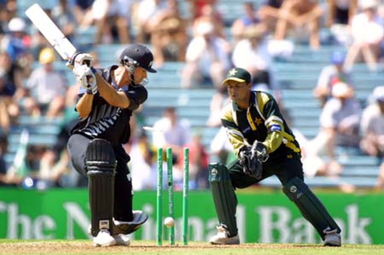 New Zealand batsman Stephen Fleming drags the ball back on to his stumps to be bowled by Pakistan off spinner Saqlain Mushtaq for 18 as wicket-keeper Moin Khan looks on. 1st One-Day International: New Zealand v Pakistan at Eden Park, Auckland, 18 February 2001.