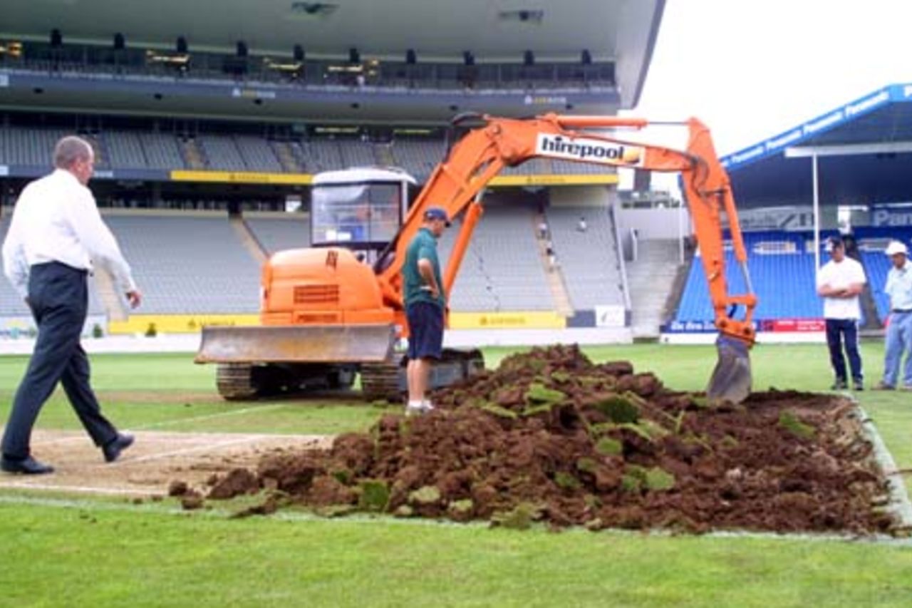 Ground workers oversee progress as a digger starts work on digging up the Eden Park wicket block, immediately after the conclusion of the match, the final one to be played on a normal turf pitch at Eden Park. A portable pitch will be laid into the ground, to allow both cricket and rugby to co-exist at the ground during the overlapping seasons. A Super 12 rugby match will be played on March 2nd, before the portable cricket will be laid in preparation for the first Test between New Zealand and Pakistan starting on March 8th. 1st One-Day International: New Zealand v Pakistan at Eden Park, Auckland, 18 February 2001.
