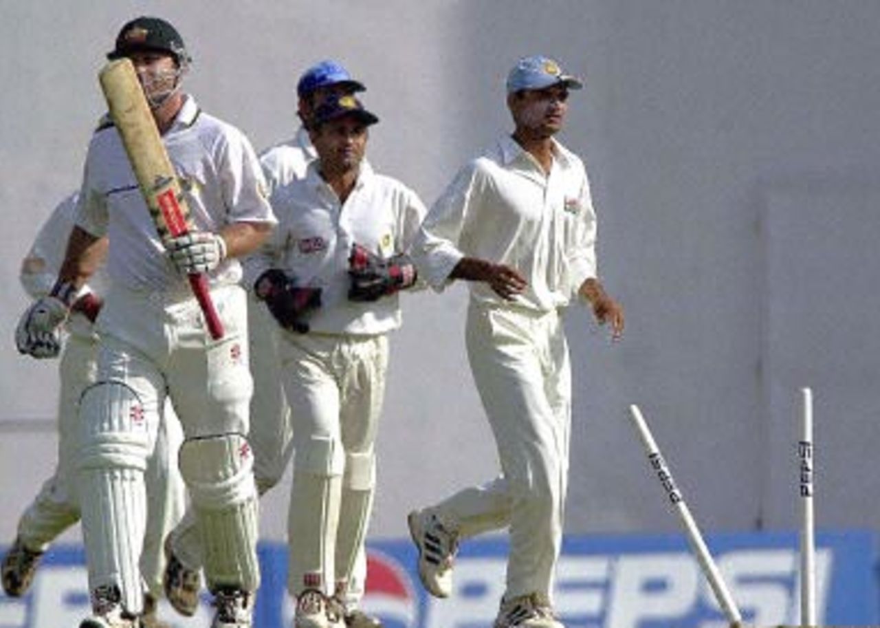 Indian players celebrate as Australian opening batsman Michael Slater (L - with bat) walks back to the pavillion after being stumped out off Indian bowler Ashish Nehra (not pictured) for 5 runs on the first day of the first three-day Test match in Nagpur, 17 February 2001. Australia were 116 for four after two hours of play.