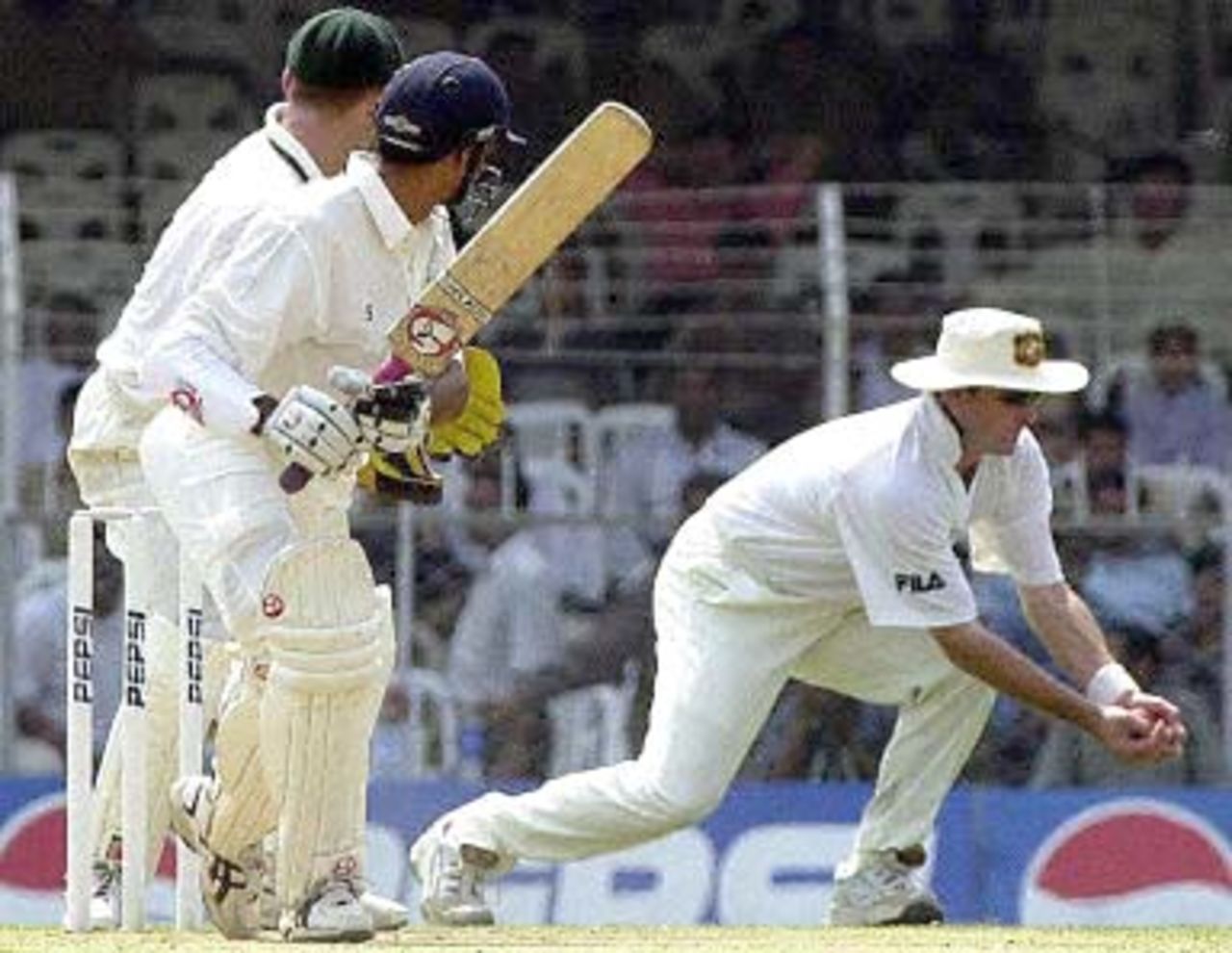 Australia's Mark Waugh (R) catches out Indian batsman Hemang Badani (C) for zero runs as Australian wicket-keeper Adam Craig Gilchrist (L) looks on during the second day of the first three-day match between India and Australia in Nagpur, 18 February 2001. India were 272 for 6 in reply to Australia's first inning's score of 291 runs.