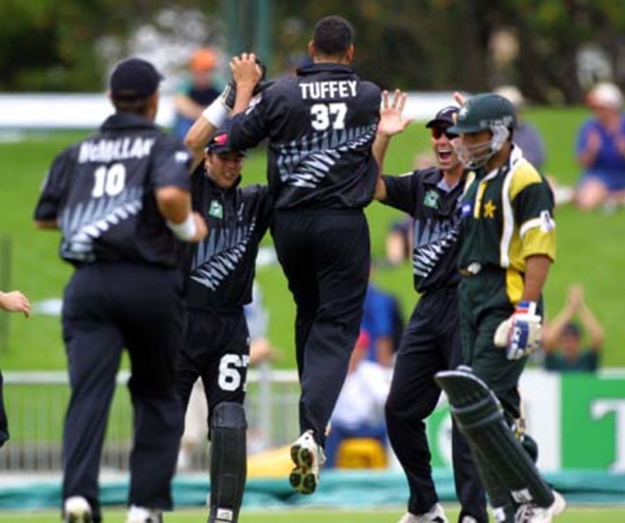 New Zealand fast medium bowler Daryl Tuffey runs down the wicket towards his team-mates, wicket-keeper Adam Parore and slip fielder Stephen Fleming, in celebration of bowling Pakistan opening batsman Saeed Anwar with the first ball of the match. Craig McMillan (left) runs to join them. 2nd One-Day International: New Zealand v Pakistan at McLean Park, Napier, 20 February 2001.