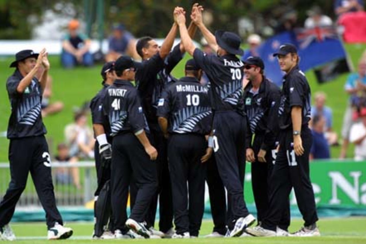 New Zealand fast medium bowler Daryl Tuffey high-fives team-mate James Franklin in celebration of bowling Pakistan opening batsman Saeed Anwar with the first ball of the match. Team-mates, from left, Chris Martin, Adam Parore (obscured), Lou Vincent, Craig McMillan, Chris Harris and Daniel Vettori gather to join in the celebrations. 2nd One-Day International: New Zealand v Pakistan at McLean Park, Napier, 20 February 2001.