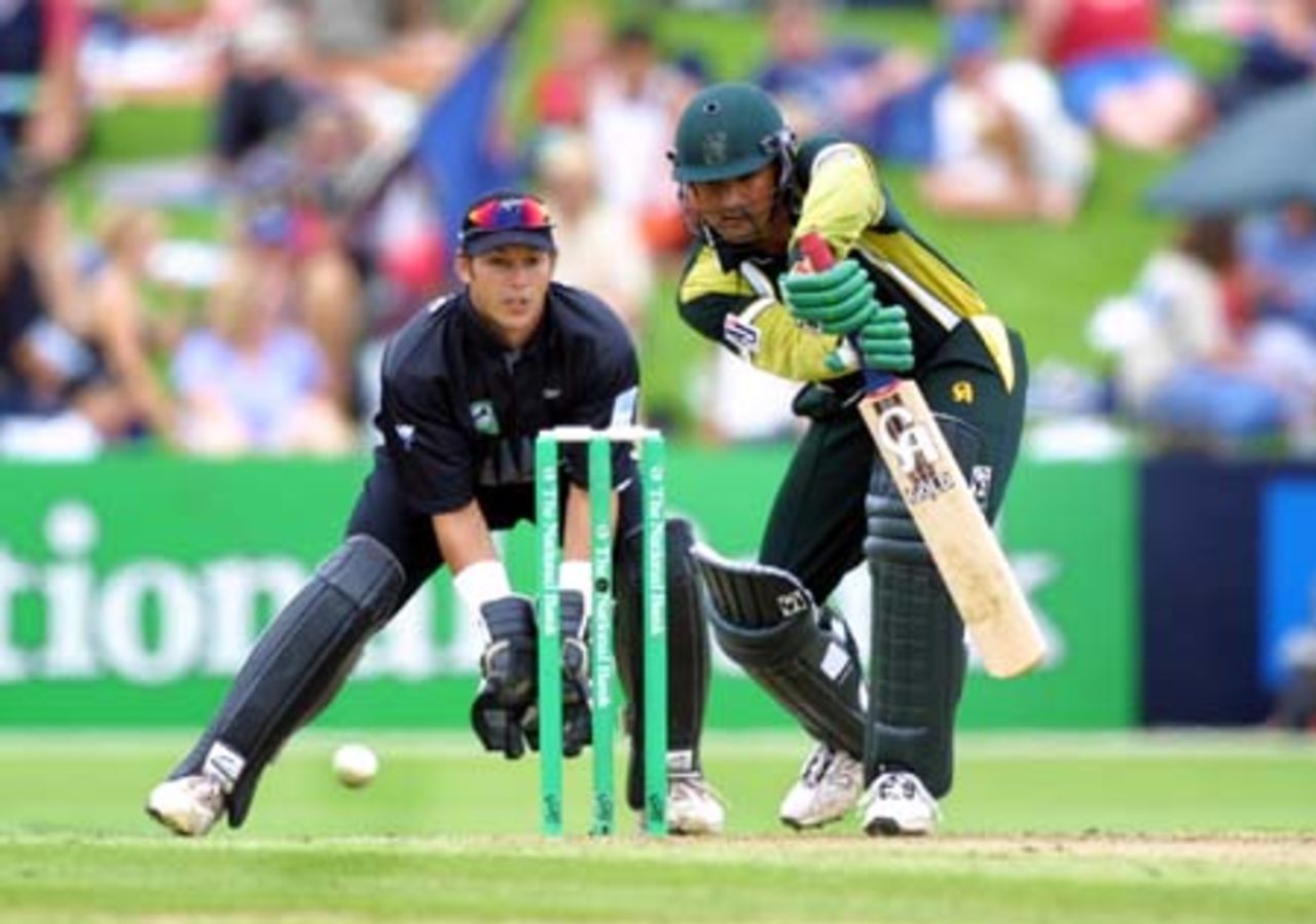 Pakistan wicket-keeper/batsman Moin Khan drives a ball from New Zealand left arm orthodox spinner Daniel Vettori into the off side during his innings of one. Wicket-keeper Adam Parore looks on. 2nd One-Day International: New Zealand v Pakistan at McLean Park, Napier, 20 February 2001.