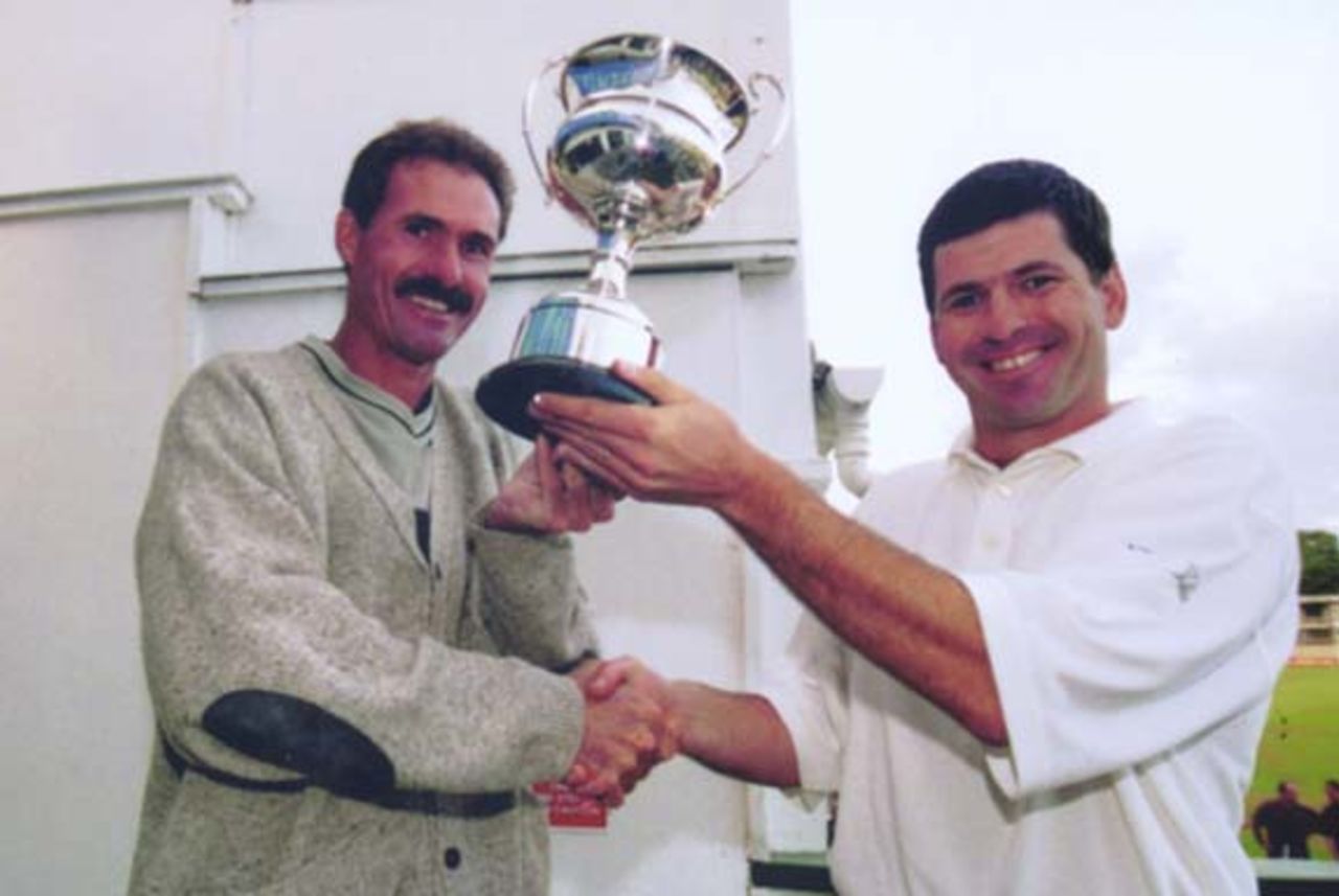 Bashley skipper Neil Slater receives the Southern Premier League Knock-Out Trophy from former South African test batsmen Jimmy Cook (Hampshire coach)