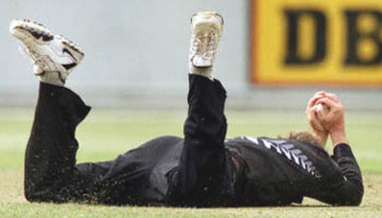 New Zealand bowler Chris Harris dives to catch Pakistan batsman Saleem Elahi in the third one day match played in Wellington, 22 February 2001. Pakistan made 243-9 from their 50 overs with New Zealand about to start their innings with the series tied at 1-1.