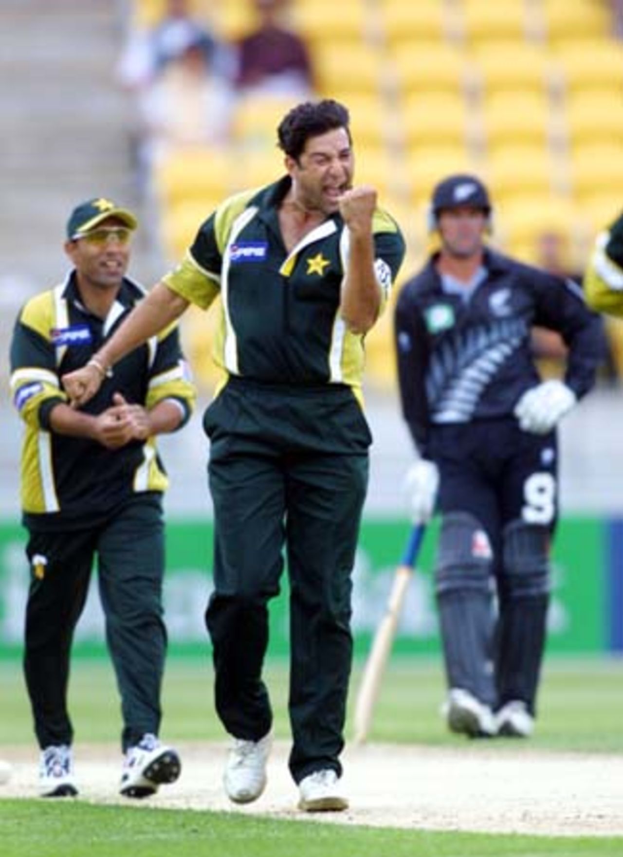 Pakistan opening bowler Wasim Akram punches the air in celebration of dismissing New Zealand opening batsman Stephen Fleming for one, adjudged out leg before wicket by umpire Dave Quested. Team-mate Saeed Anwar approaches to congratulate him, while opening batsman Nathan Astle leans on his bat watching in the background. 3rd One-Day International: New Zealand v Pakistan at WestpacTrust Stadium, Wellington, 22 February 2001.