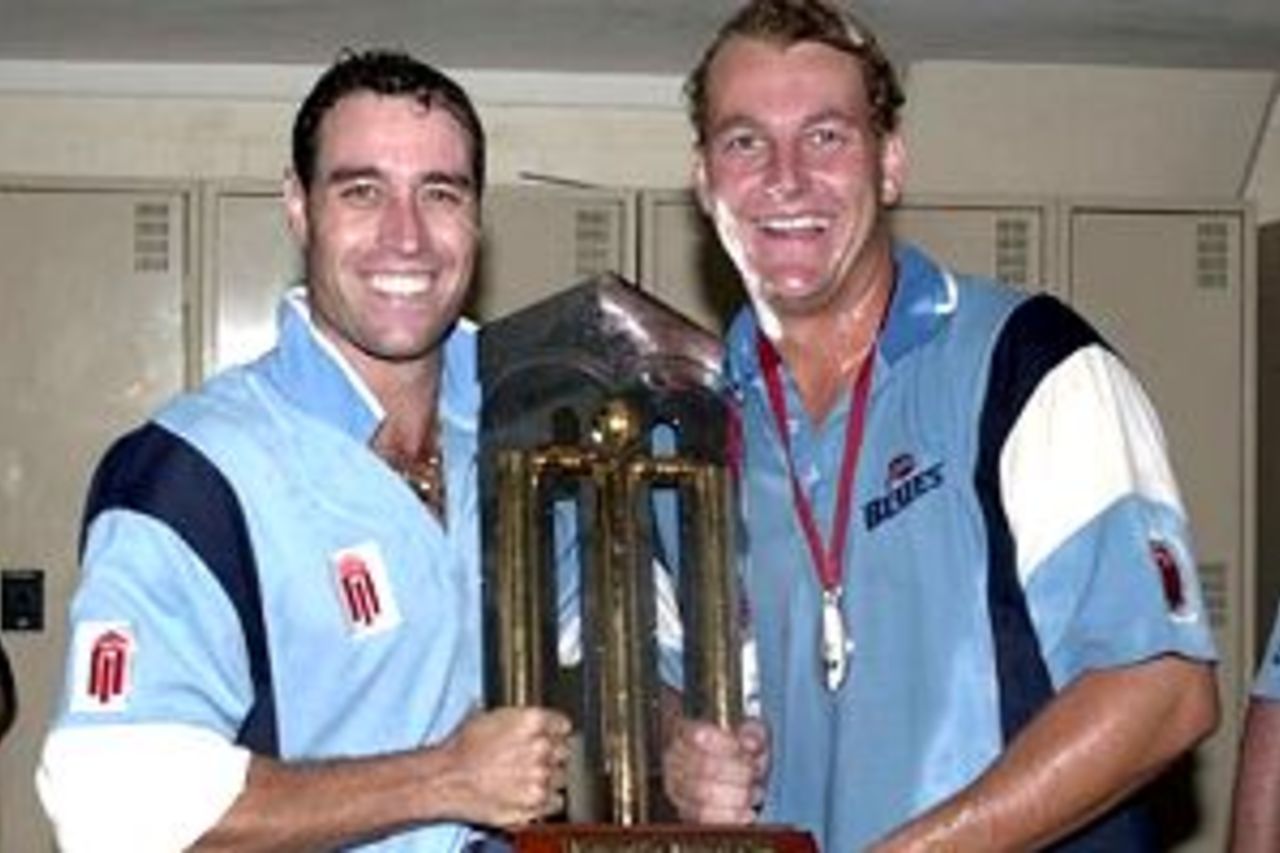 25 Feb 2001: Michael Bevan #5 and Shane Lee#6 for the NSW Blues celebrate with the Mercantile Mutual Trophy, after the Mercantile Mutual Cup One Day final, between the Western Warriors and the NSW Blues, played at the WACA, Perth, Australia. The NSW Blues defeated the Western Warriors by 6 wickets.