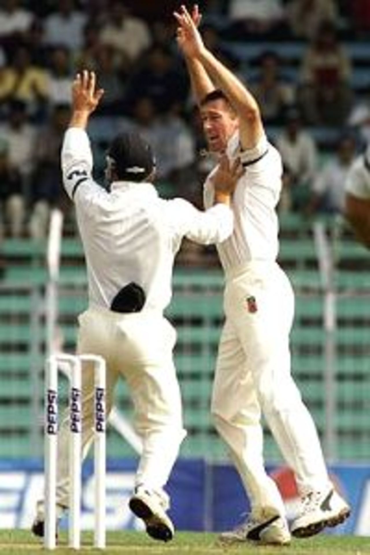 27 Feb 2001: Glenn McGrath (right) and Justin Langer of Australia celebrate after Sadagopan Ramesh of India was caught by Adam Gilchrist off McGrath's bowling for two, during day one of the first test between India and Australia, played Wankhede Stadium, Mumbai, India.