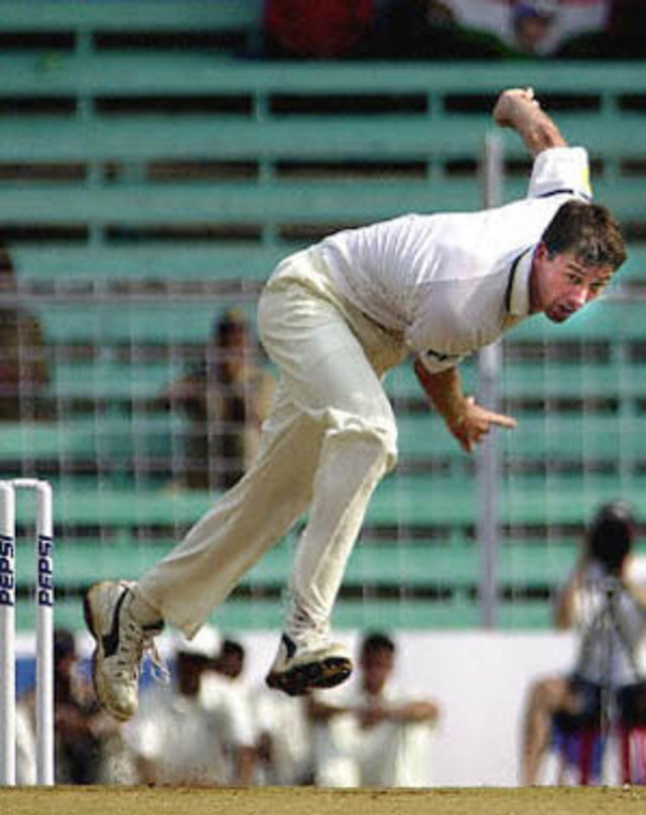 Australian pace bowler Glenn McGrath bowls to Indian opener Shiv Sundar Das (not in the picture) on the first day of the first test  match between Indian and Australia in Wankhade stadium in Bombay 27 February 2001. McGrath took an early wicket of India's Sadagopan Ramesh as India were struggling at 54 for 4 after less than two hours of play.
