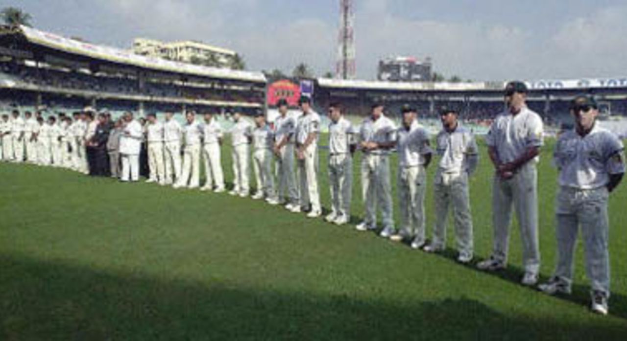 Australian and Indian cricket players observe a minute of silence to pay their tribute to Australian legend Donald Bradman, at Wankhade Stadium prior to the start of the first Test between the two countries in Bombay, 27 February 2001. Bradman died 25 February at the age of 92 at his home in Adelaide, Australia.