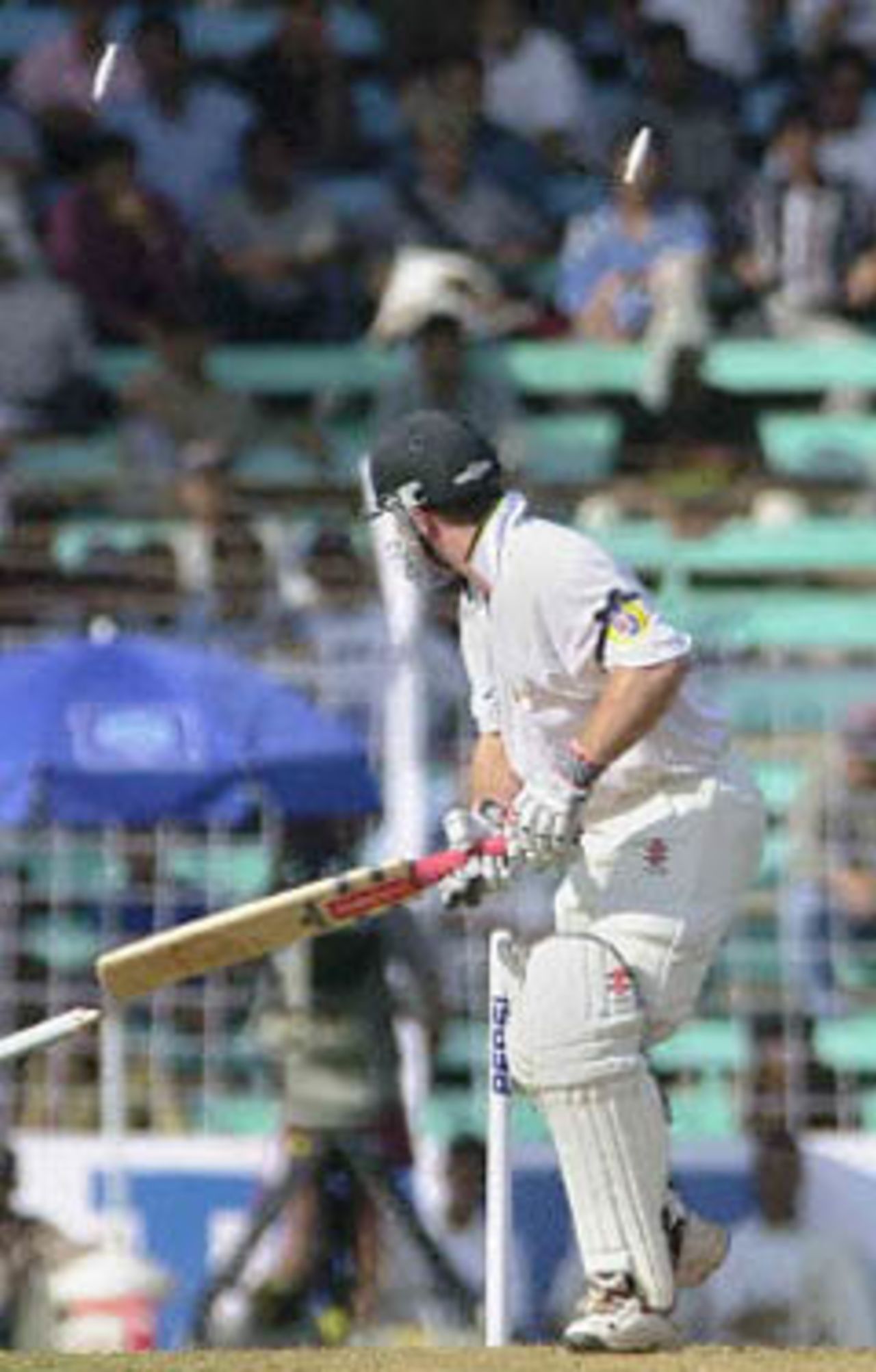 Australian batsman Michael Slater watches his wickets be uprooted off the bowling of Indian seamer Ajit Agarkar on the opening day of the first Test match between India and Australia at Wankhade stadium in Bombay, 27 February 2001. Australia were 49 for 1 in reply to India's first innings score of 176.